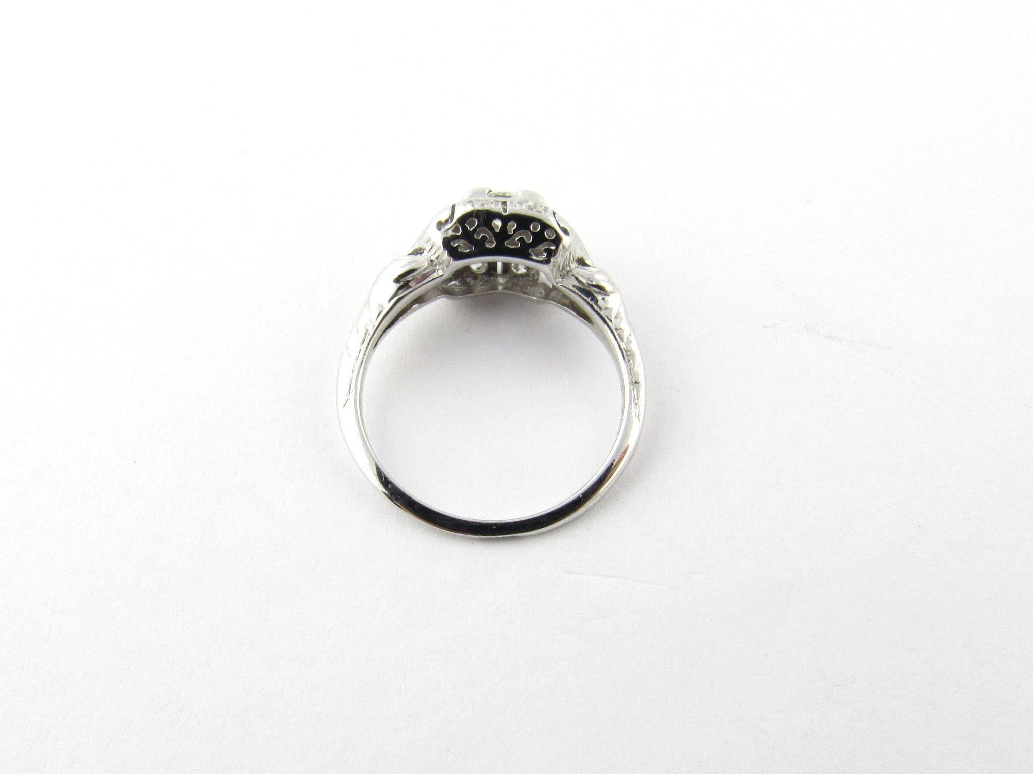 Vintage 18 Karat White Gold Diamond Engagement Ring Size 5- 

This exquisite engagement ring features one center round brilliant cut diamond surrounded by six round single cut diamonds set in 18K white gold. 

Center stone approximate diamond