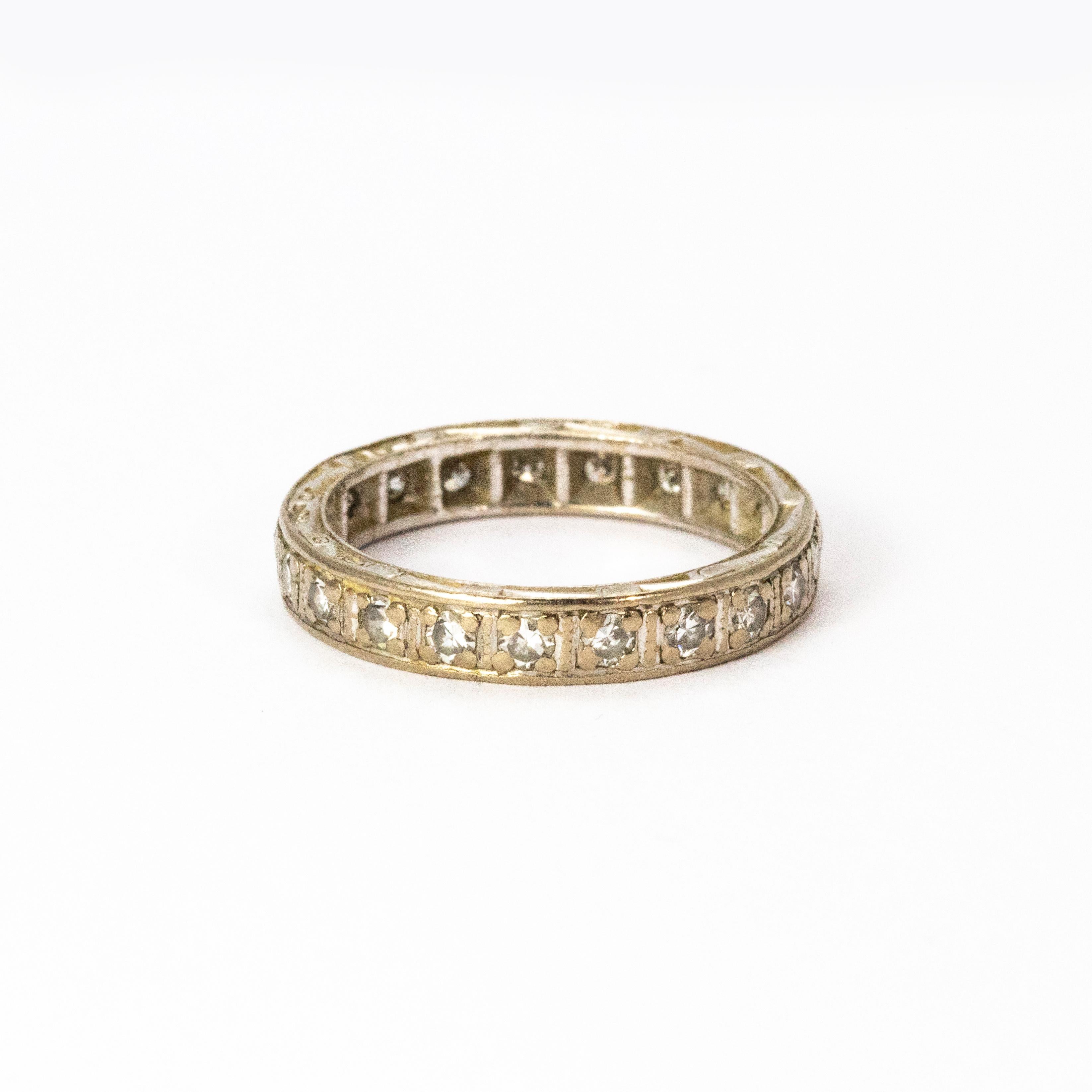 An elegant vintage eternity band with 22 round brilliant cut white diamonds in square settings. Modelled in 18 karat white gold, each stone weights 5 points. Total diamond weight 1.10 carats.

Ring size: H 1/2 or 4 

(Certification to follow)


