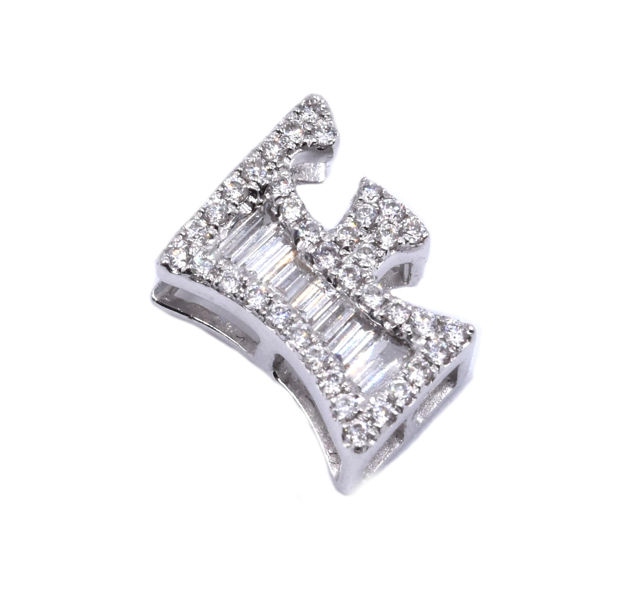 Designer: custom 
Material: 18K white gold
Diamonds: 45 round and baguette cut = .31cttw
Color: G
Clarity: VS
Dimensions: pendant measures 10.71 X 7.8mm
Weight: 1.41 grams
