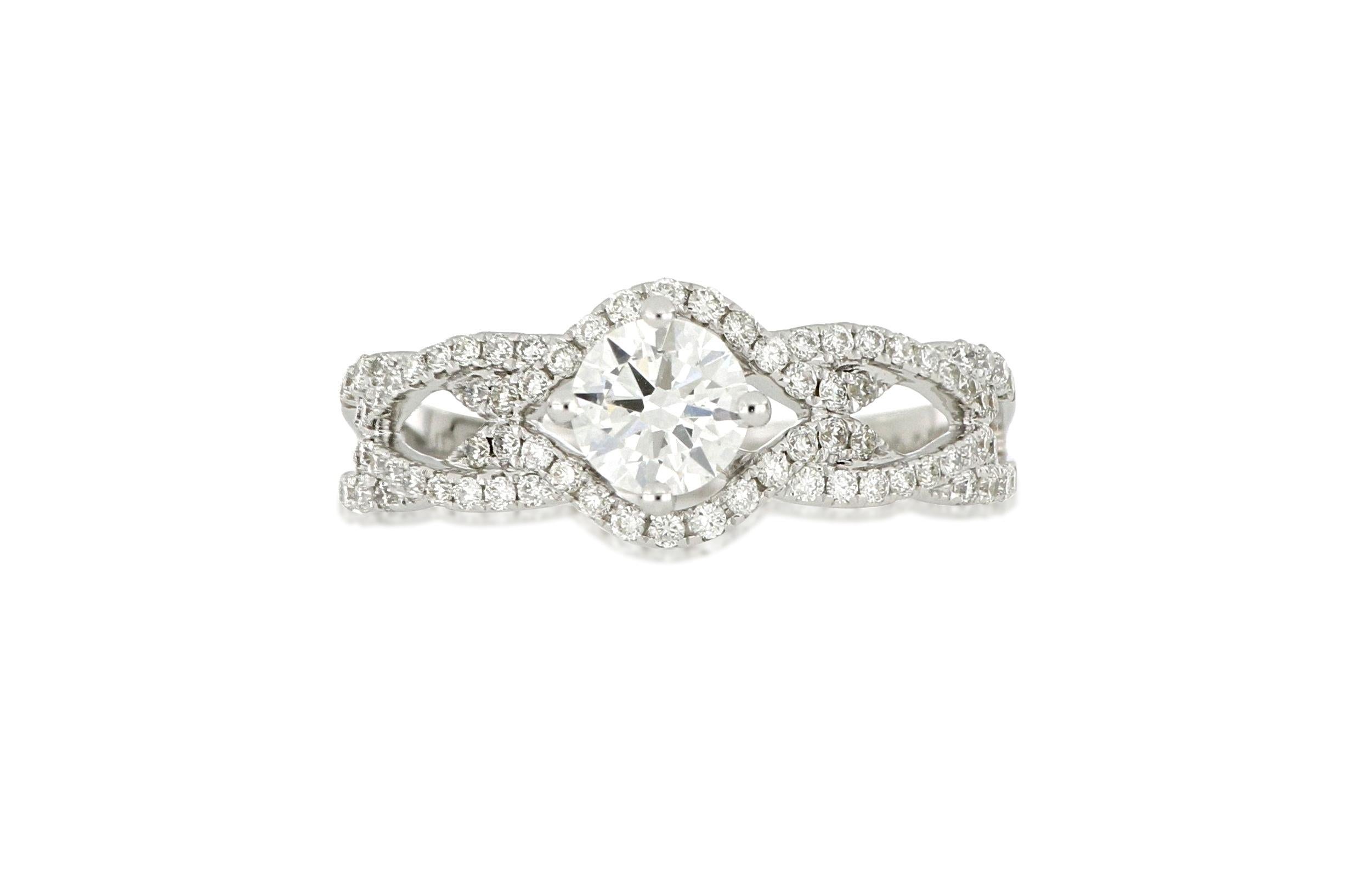 A beautiful diamond ring, set with a brilliant-cut diamond weighing 0.50 carats, within brilliant diamonds weighing approximately 0.35 carats, mounted in 18 Karat white gold. Accompanied by certificate  from GIA. Certificate No. 2166327072
O’Che