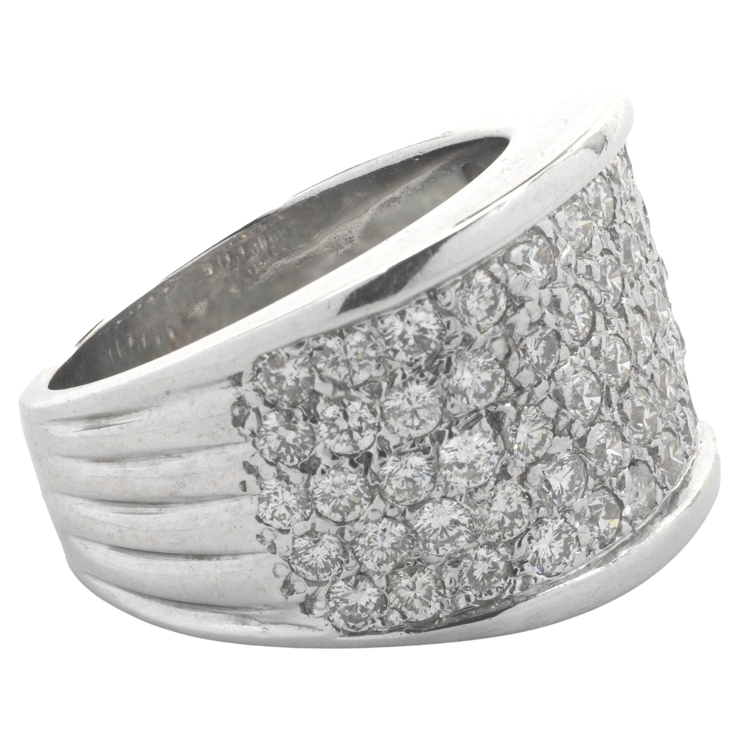 Designer: custom
Material: 18K white gold
Diamond:  58 round brilliant and baguette diamonds= 0.90cttw
Color: I
Clarity: SI1
Ring size: 6.25 (please allow two additional shipping days for sizing requests)
Weight:  2.66 grams
