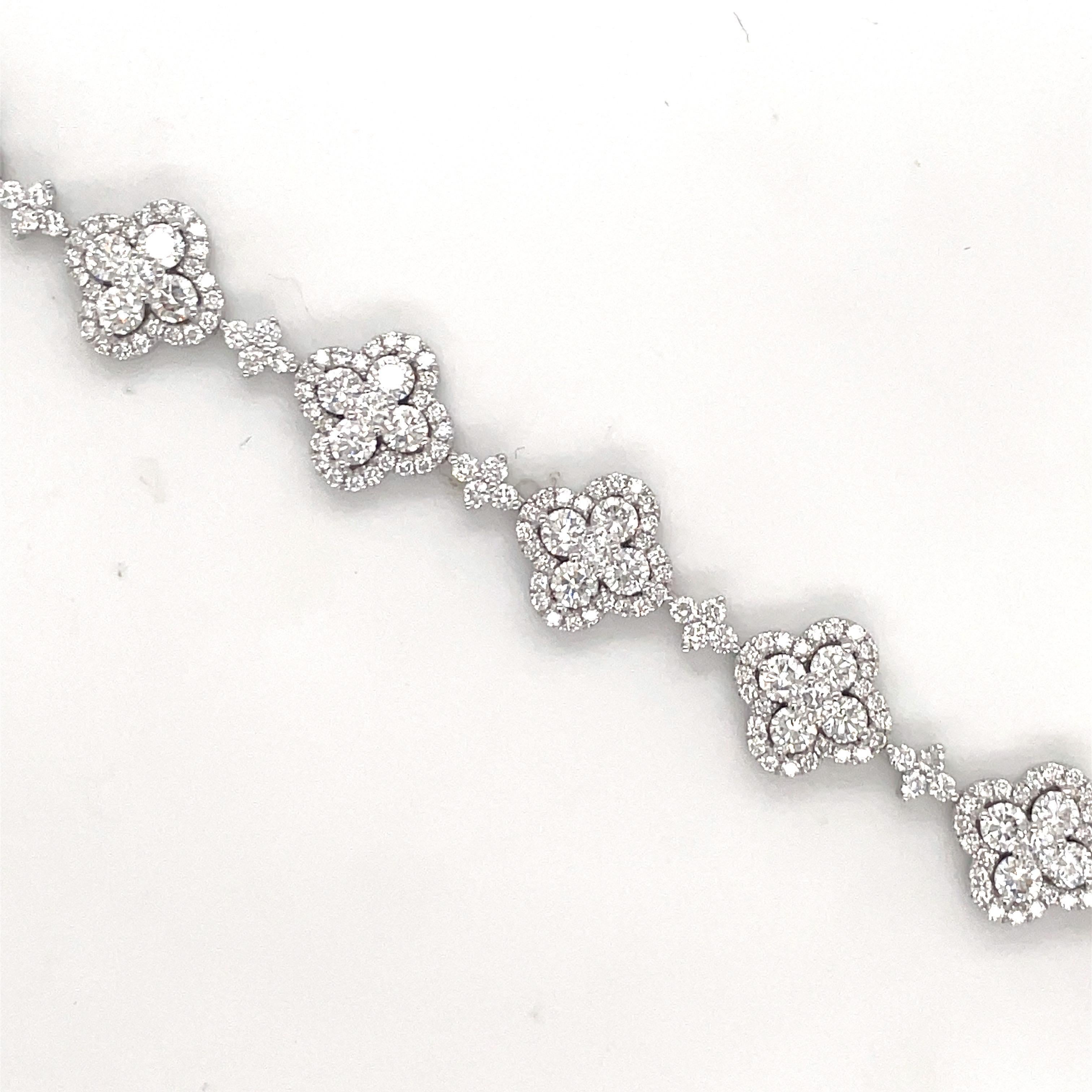 18 Karat White gold bracelet featuring 11 diamond flowers flanked with a diamond halo weighing a total of 6.55 carats.
44 Diamonds weighing 3.71 carats
319 Diamonds weighing 2.84 carats
Color G-H
Clarity SI