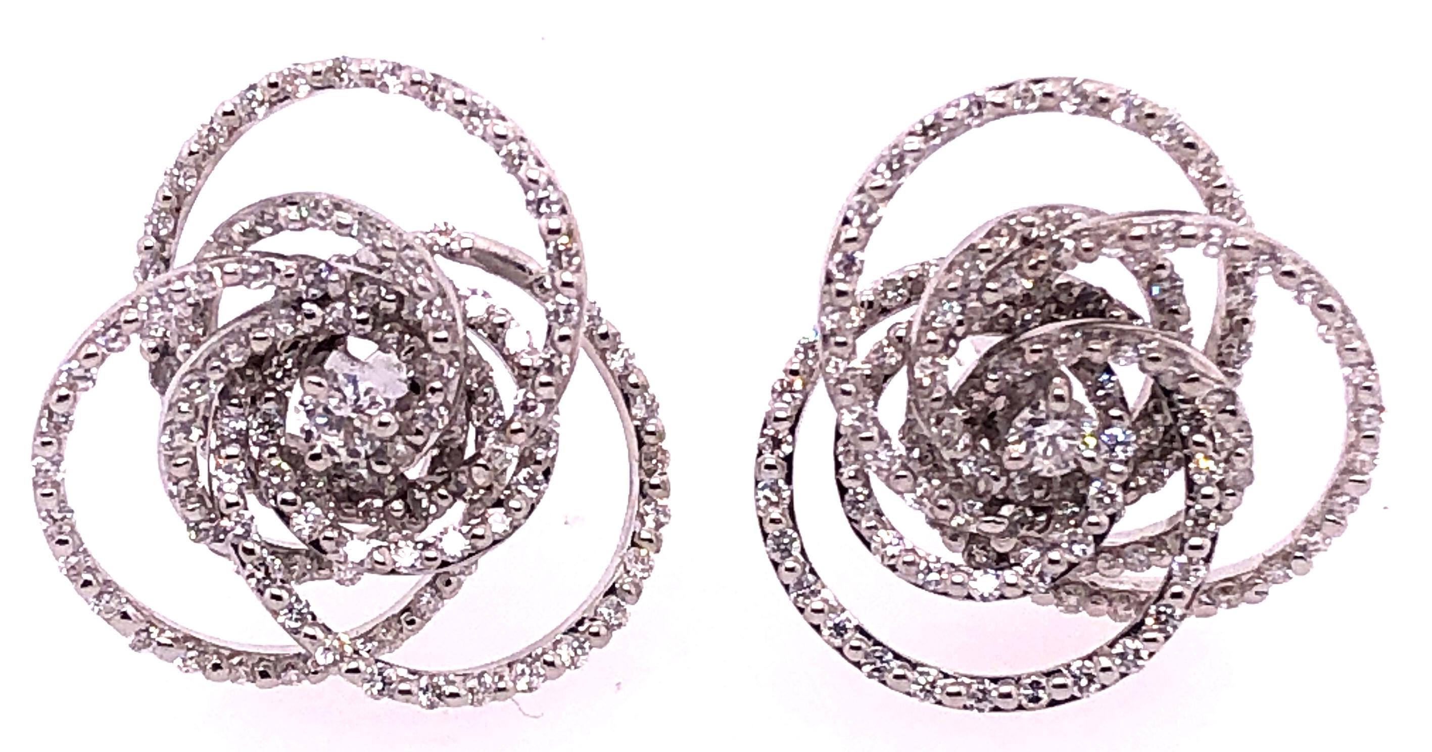 18 Karat White Gold Diamond Flower Swirl Stud Earrings by H2 at Hammerman.
H2 at Hammerman diamond swirl stud earrings 18K white gold and pave diamond flower swirl stud earrings. Total diamond carat weight is 1.41, diamond color is G, diamond