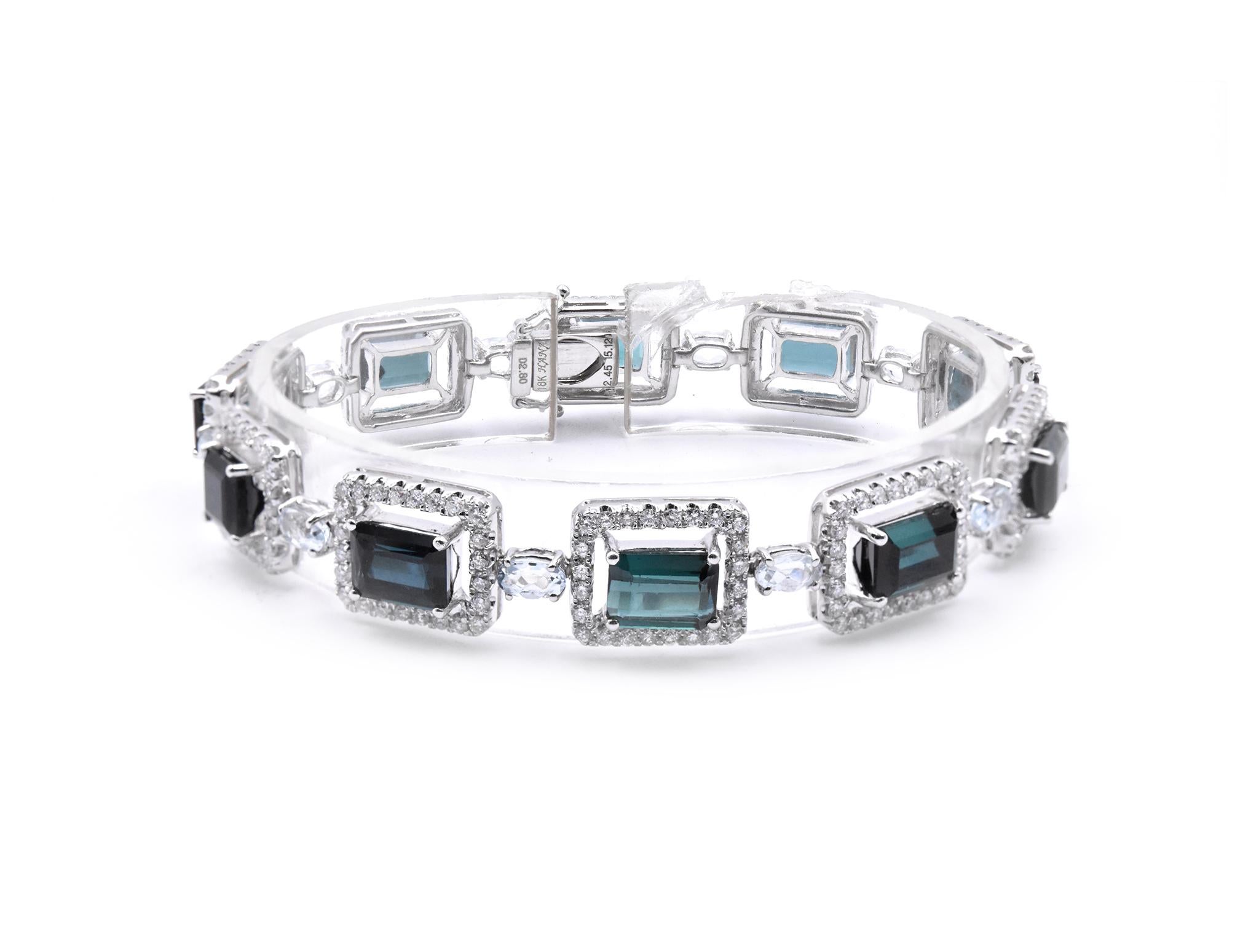 Designer: custom
Material: 18k white gold
Diamond: 234 round brilliant cut = 2.34cttw
Color: G
Clarity: VS
Aquamarine: 10 oval cuts 
Green Tourmaline: 10 radiant cuts 
Dimensions: bracelet will fit a 7-inch wrist 
Weight: 25.65 grams
