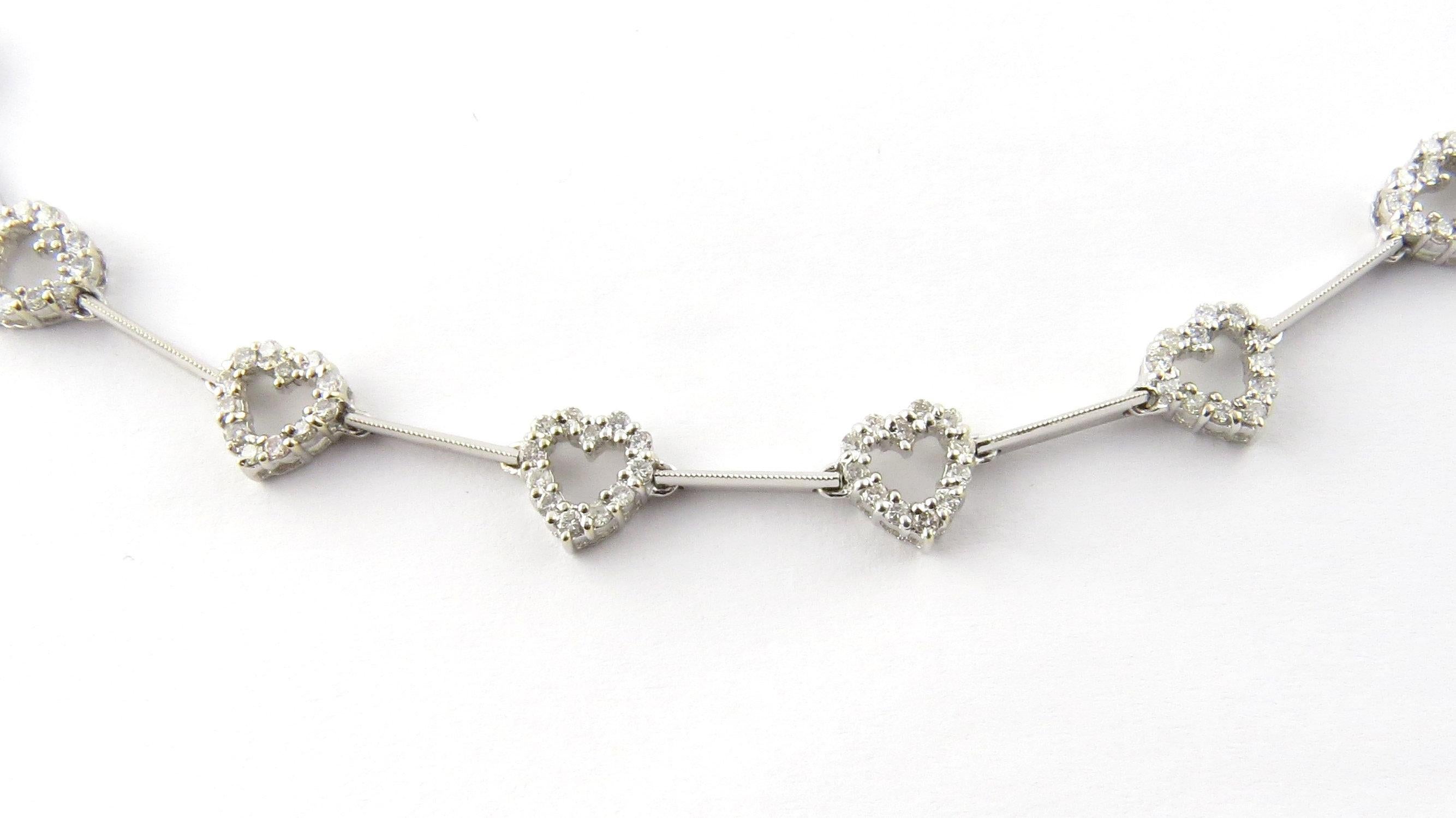 Vintage 18 Karat White Gold Diamond Heart Necklace- 
This exquisite necklace features 11 sparkling hearts (8 mm x 8 mm) each decorated with 12 round brilliant cut diamonds and set on a stunning beaded 18K white gold necklace. 
Approximate total