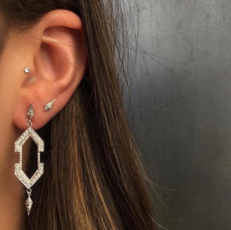 Diamond Hexagon Geometric Dangle Earrings feature white diamond pave hexagon frames with empty space in the center and finished by diamond drops at the tips 
Includes 18k White Gold Push Closure Earring Backings 
18k White Gold, White Diamonds 
From