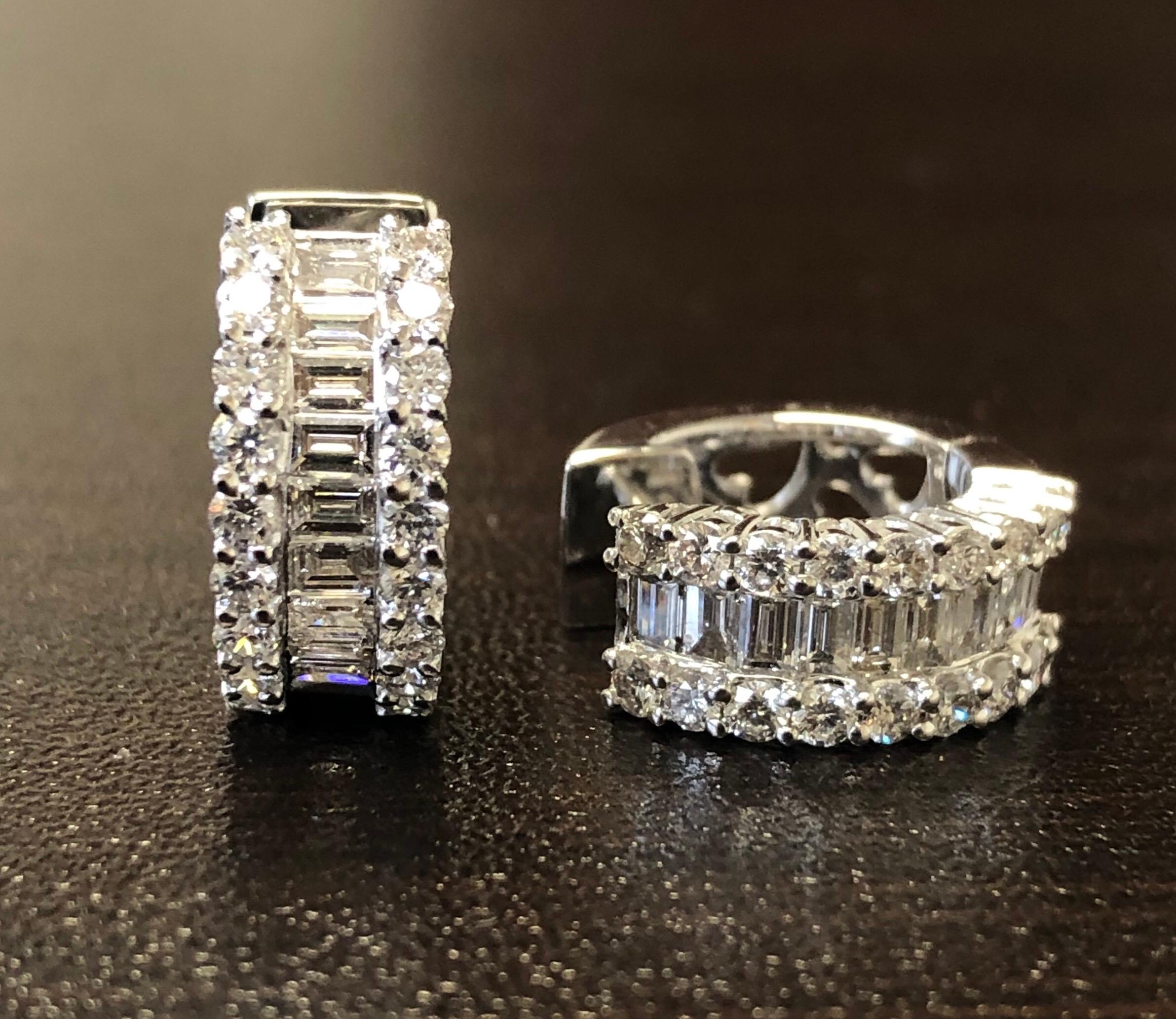 Diamond Huggies set in 18K white gold. The diamonds are set halfway on the outside with baguette stones in the middle and 2 rows of round diamonds. The stones are F color, VS1-VS2 clarity. The total carat weight is 1.74, the carat weight of round