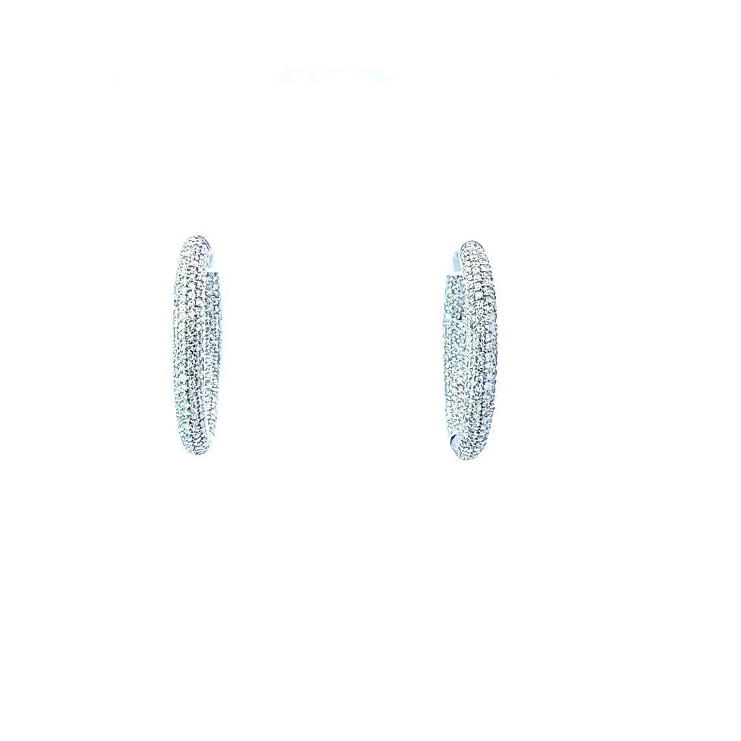 These lovely oval-shaped earrings are in 18 karat white gold and support an estimated total of 1.00 carat of sparkling diamonds!