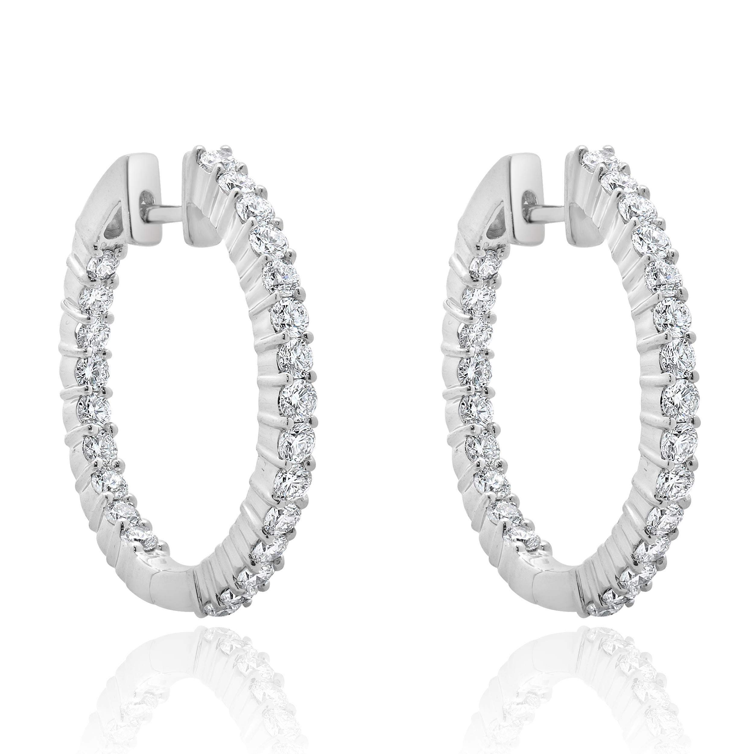 Designer: custom design
Material: 18K white gold
Diamonds: round brilliant cut = 1.75cttw
Color: G
Clarity: VS1-2
Dimensions: earrings measure 24mm in length
Weight: 8.12 grams
