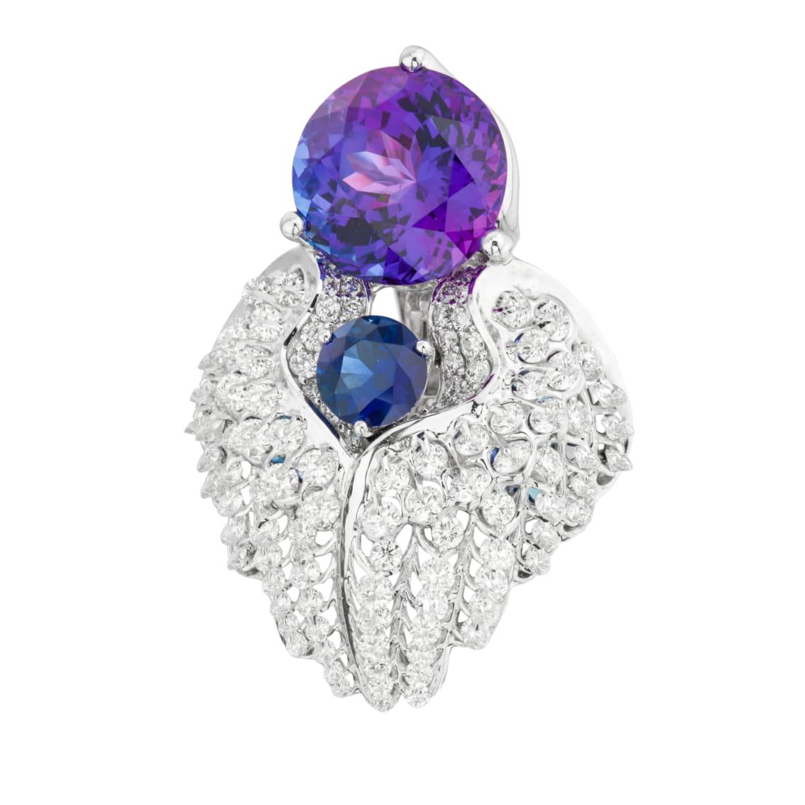 An  intensive blue Tanzanite is  mounted on angel feather diamond frame, employed patented gemstone setting 