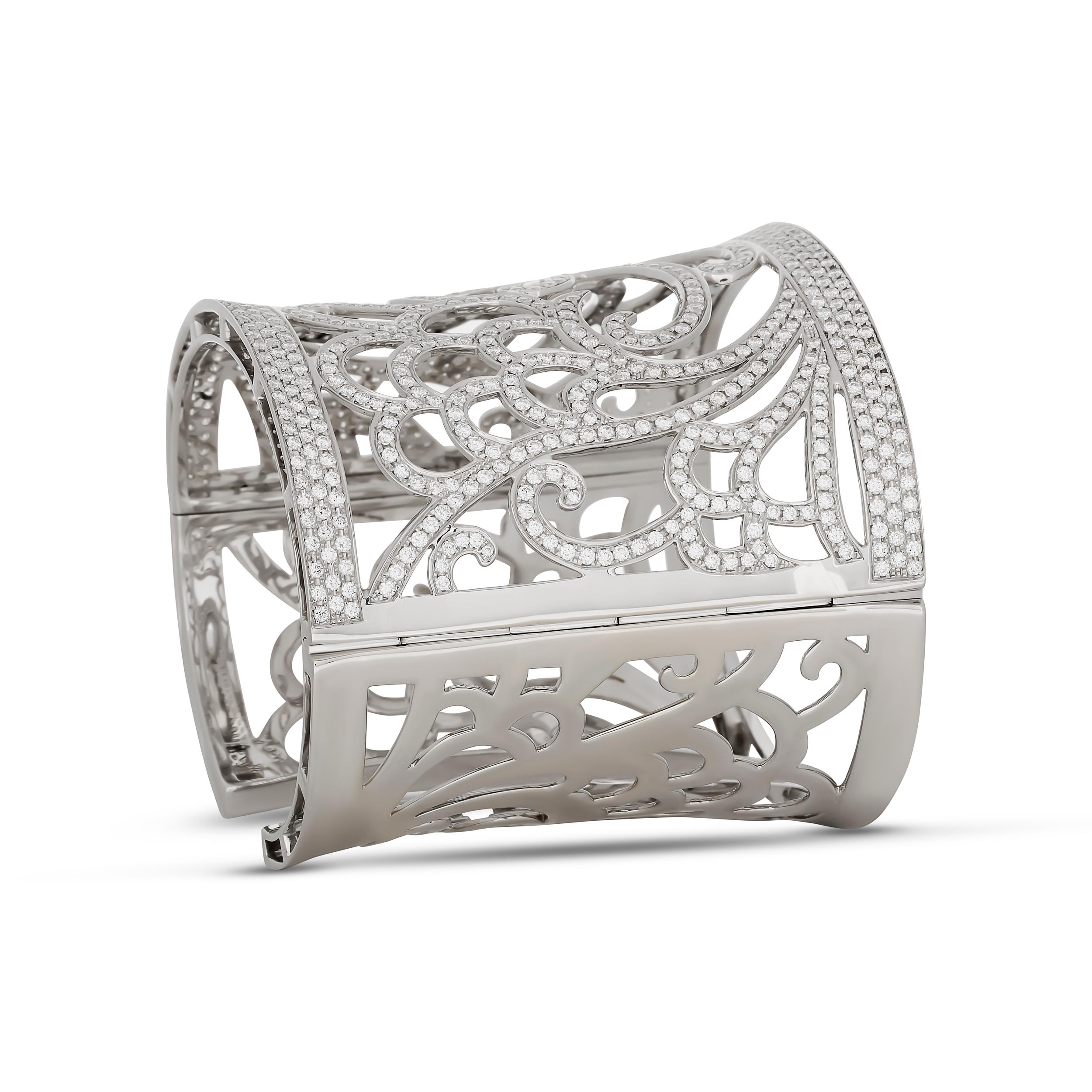 This exquisite wide cuff bangle is crafted from white gold and features an intricate filigree design, entirely pavé-set with dazzling diamonds.

It has approximately 6.00 total carat of diamonds; they are F-G color and VS clarity.

2 3/8