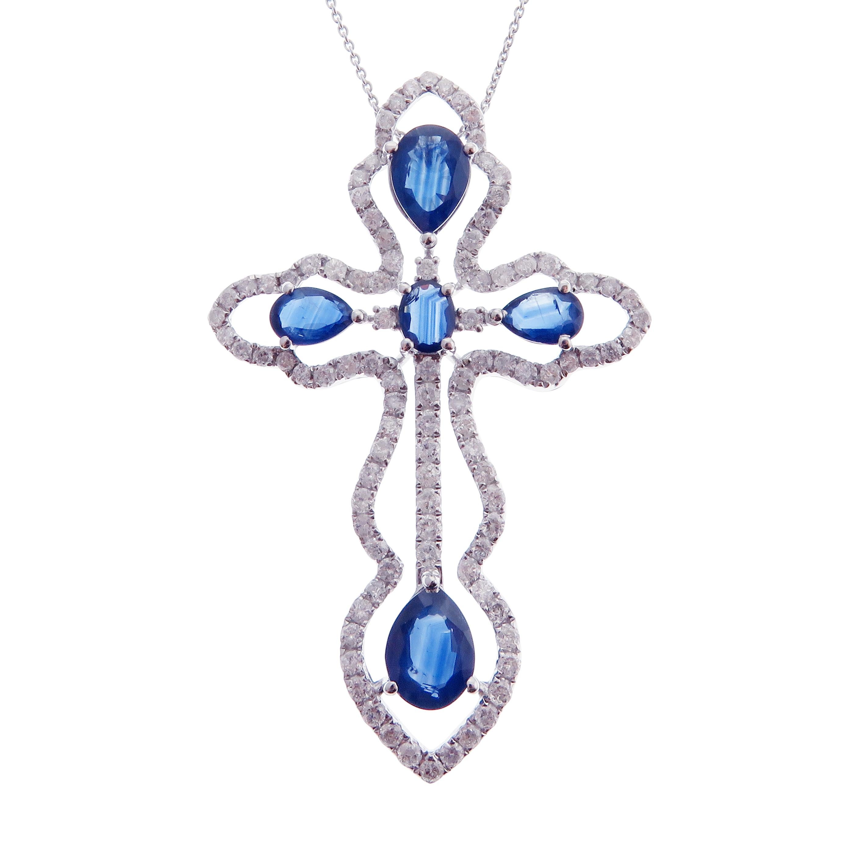 This cross motif necklace is crafted in 18-karat white gold, weighing approximately 1.55 total carats of SI Quality white diamond and 4.10 total carats of blue sapphires. 

Necklace is 16