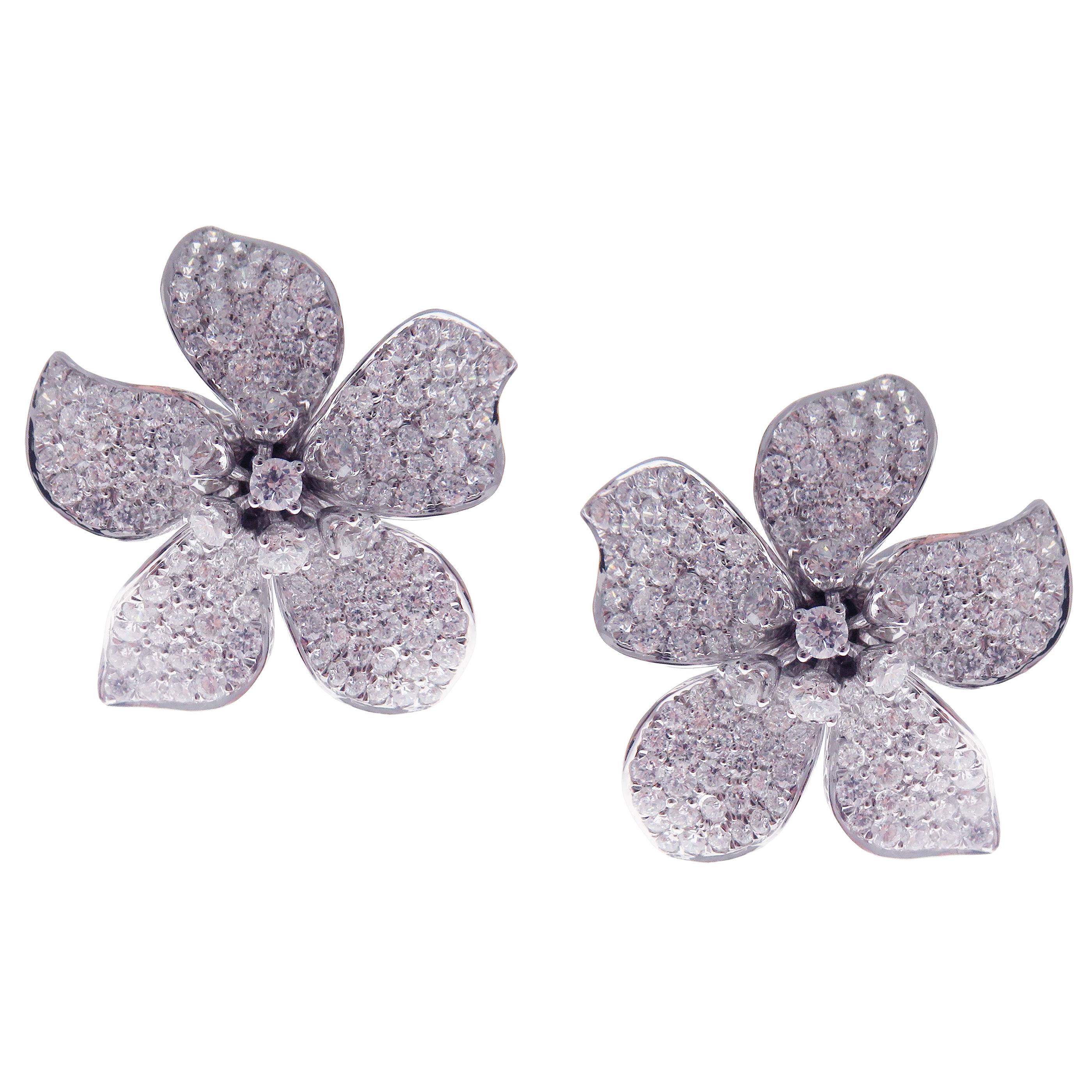 This large diamond classic pave five petals flower earring is crafted in 18-karat white gold, featuring 303 round white diamonds totaling of 6.53 carats. 
Approximate total weight 14.41 grams.
These earrings come with push back post backings.
SI-G