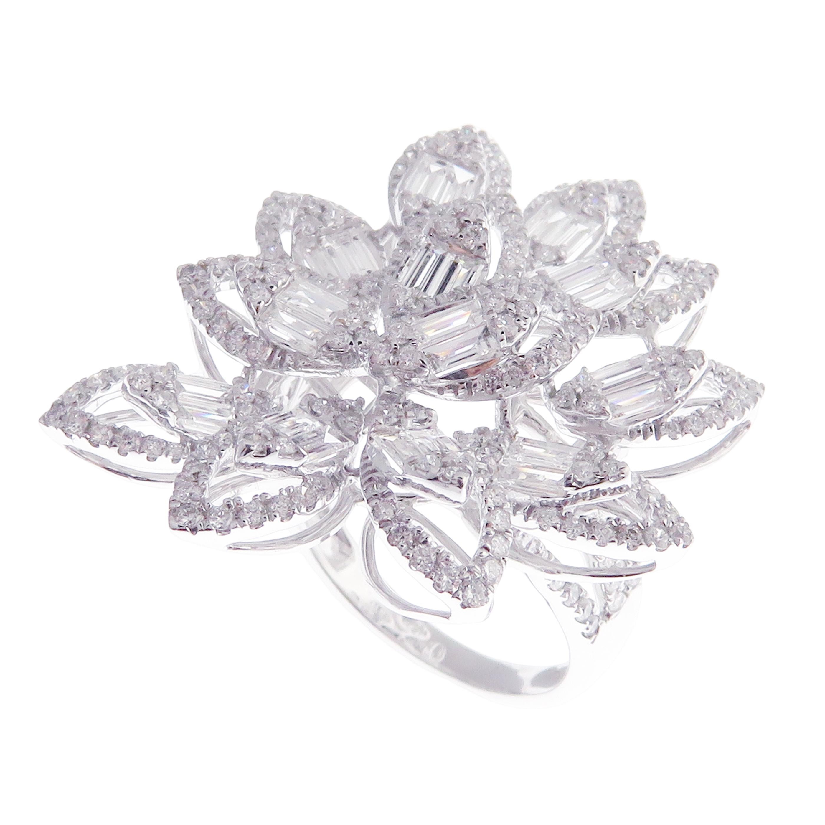 This flower baguette, diamond ring is crafted in 18-karat white gold, weighing approximately 2.67 total carats of SI-V Quality white diamonds. This ring is comfortable and can be sized 