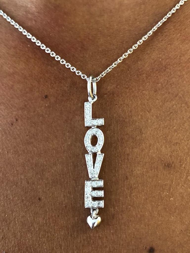 The vertical expression of love, expressed by this beautiful LOVE pendant/necklace, made in 18 Kt White Gold, set with 33 round diamonds 0.30 carats. Also available in 18 Kt Yellow Gold.
The pendant length is 1-3/4 inches(4.5 cm)

We manufacture all