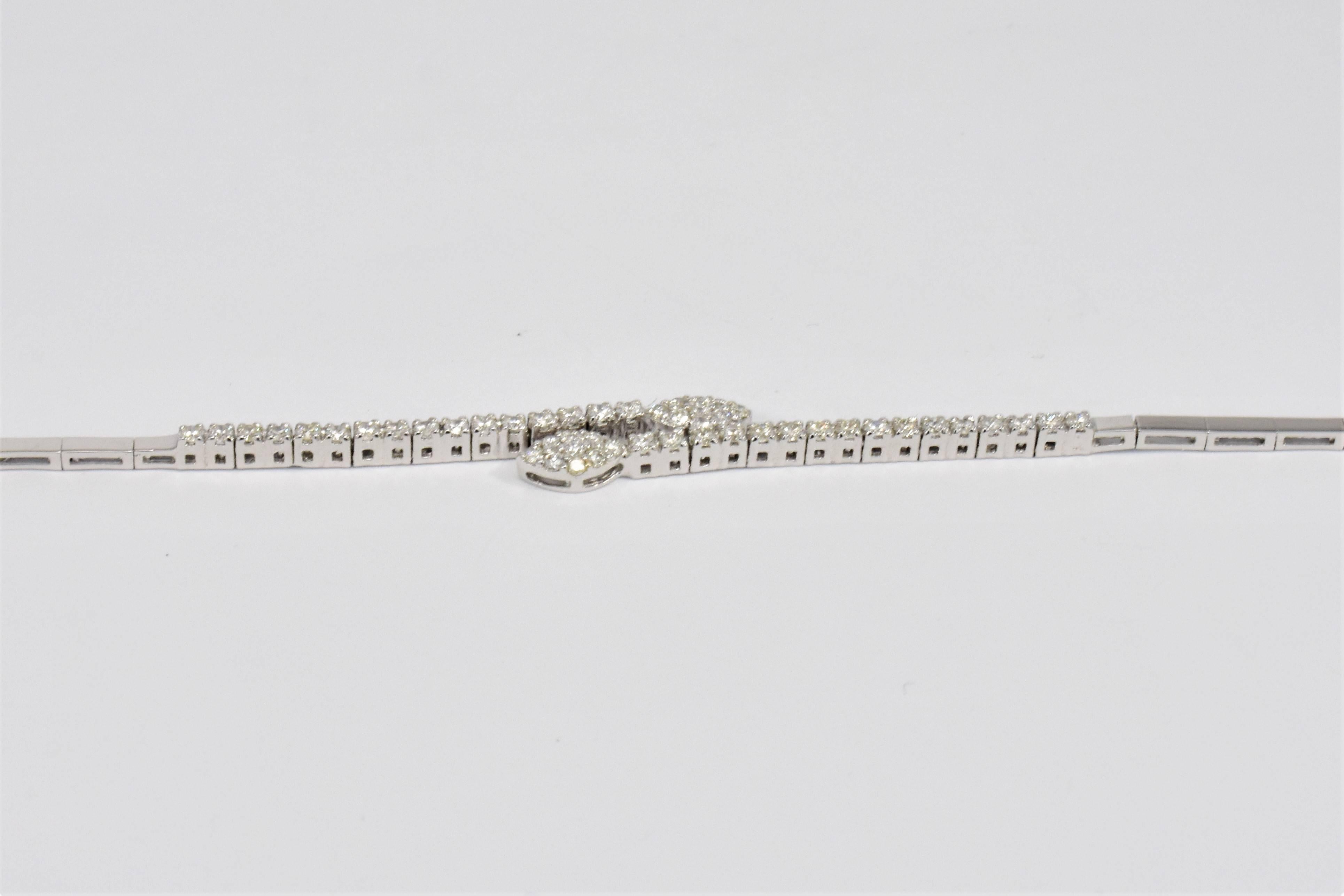 A lovely bracelet reminiscent of leaf buds or flames made up in many sparkling brilliant cut diamonds. The carefully set small round brilliant diamonds with larger diamonds in the centre form the marquise shapes to dazzling effect set in 18ct white
