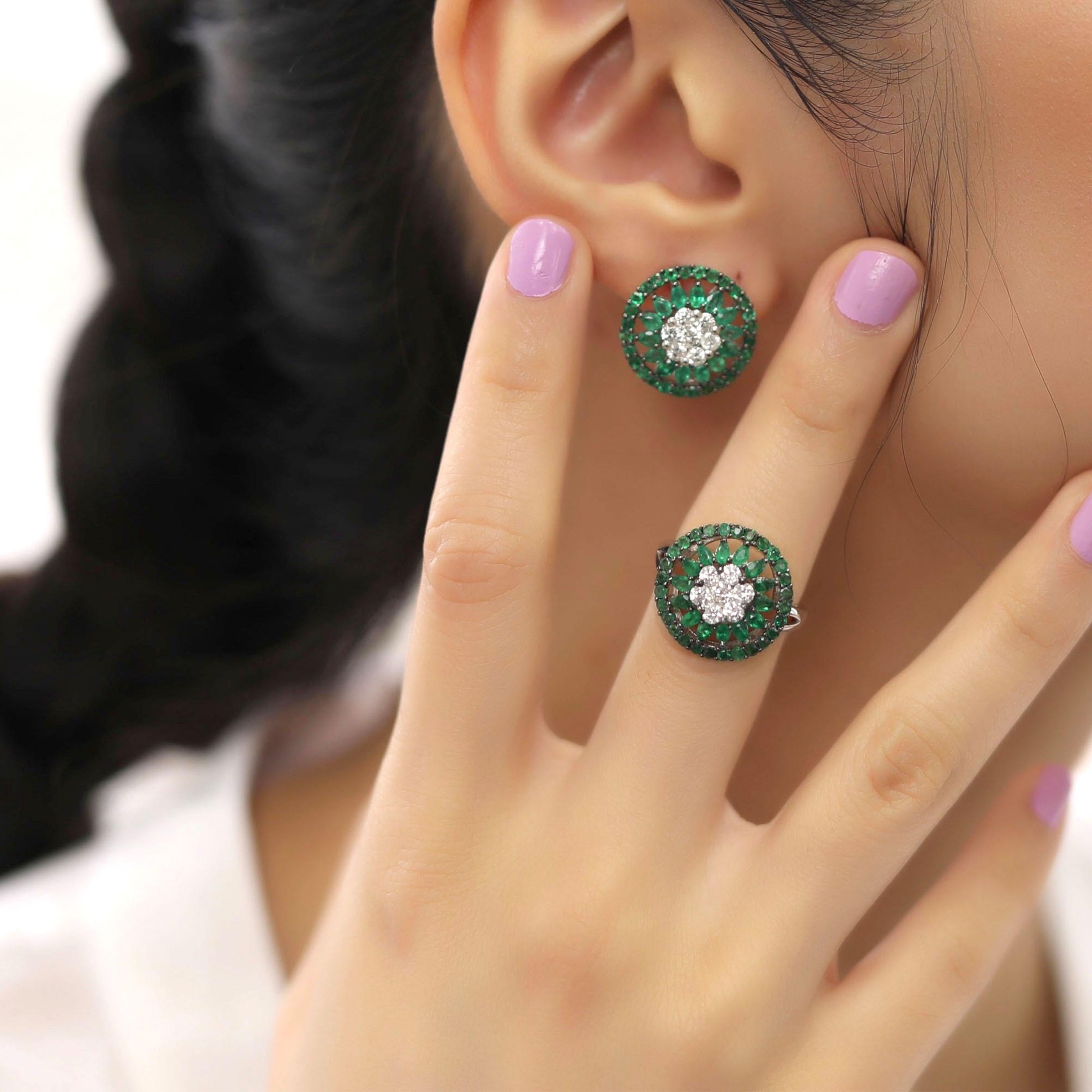 This medium circle flower motif earring and ring set is crafted in 18-karat white gold, weighing approximately 1.44 total carats of SI-H Quality white diamonds and 4.00 total carats of emerald stones. The ring is comfortable and can be sized 