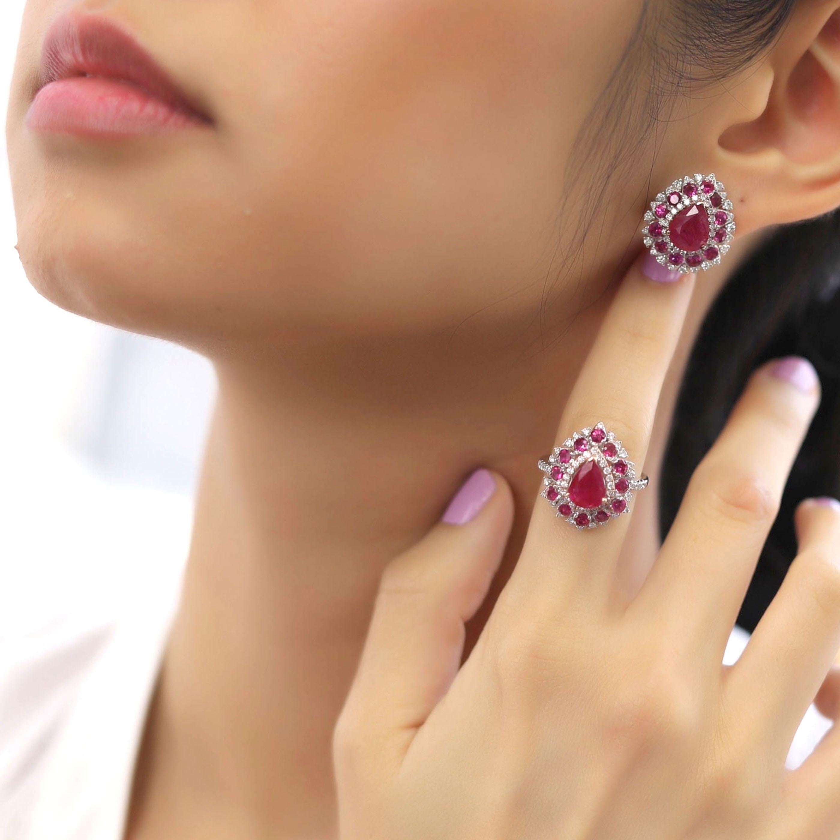 This medium ruby earring and ring set is crafted in 18-karat white gold, weighing approximately 1.31 total carats of SI-H Quality white diamonds and 9.60 total carats of ruby stones. The ring is comfortable and can be sized 