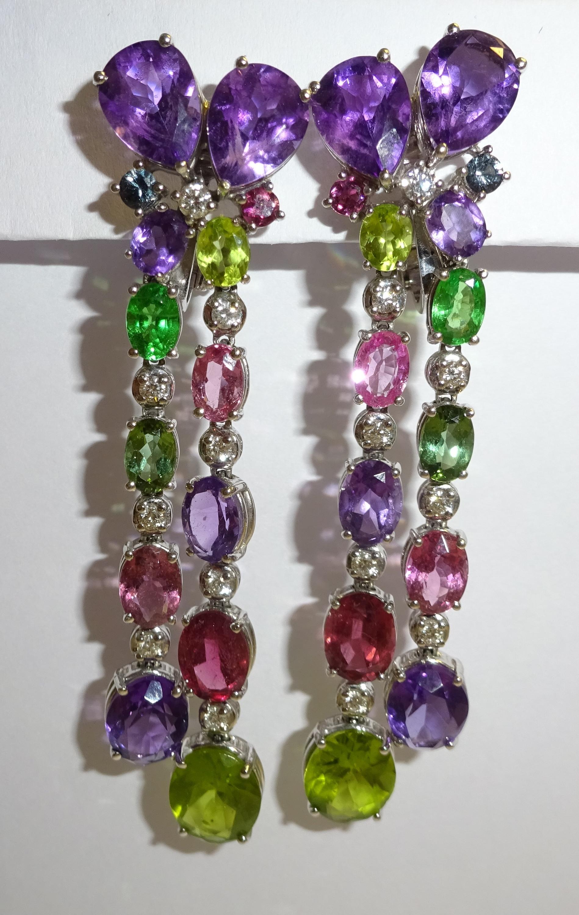 18 Karat White Gold Diamond and multicolor stones Dangle Earrings

16 Diam. 0.82 ct.
4 Sapphire pink 1.07 ct
4 Tourmaline pink 4.52 ct
2 Tourmaline green 1.21 ct
2 Garnet green 1.10 ct
4 Peridot 5.82 ct
10 Amethyst 11.26 ct







Founded in 1974,