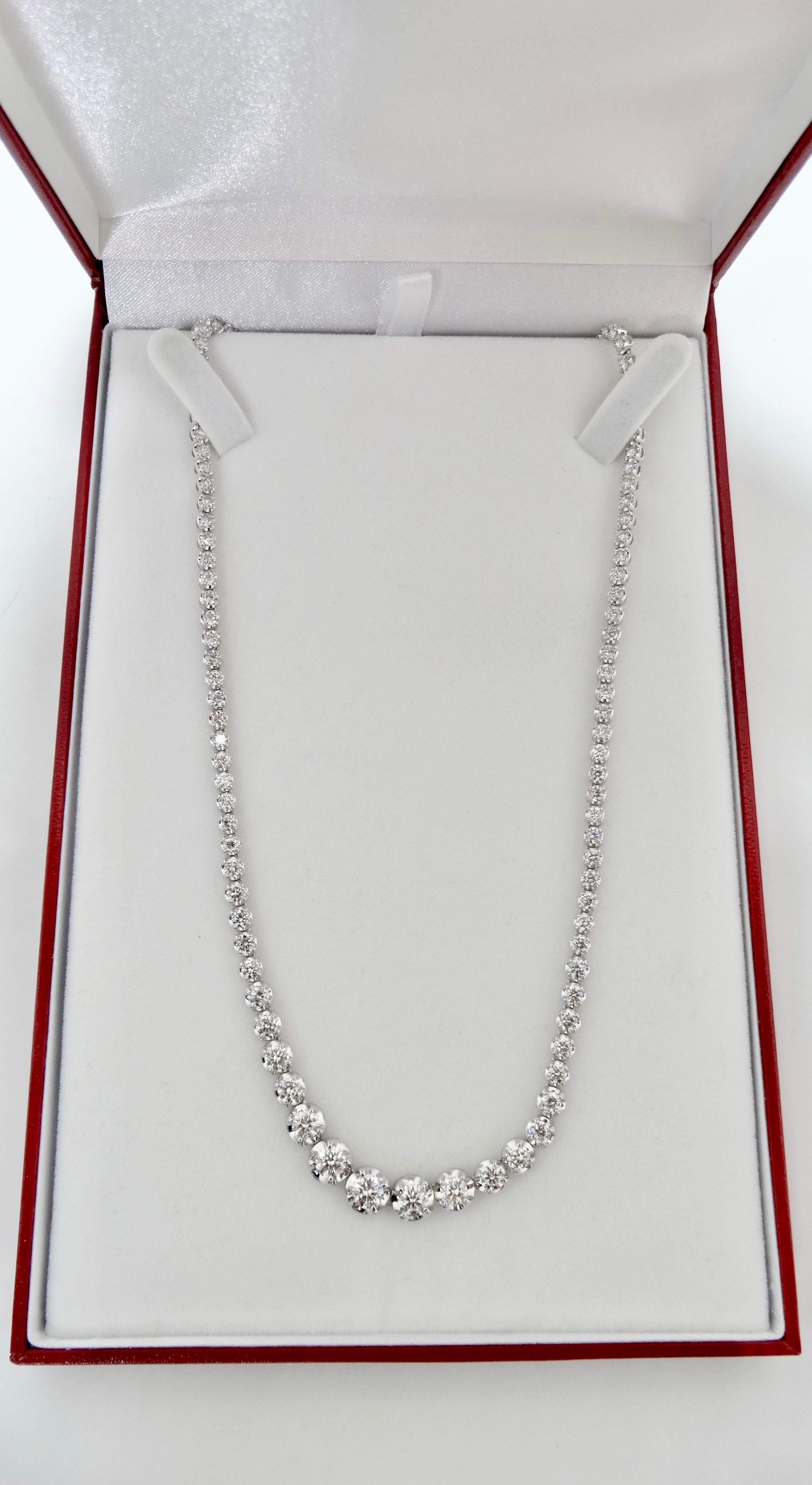Gorgeous and timeless, this necklace is USA made and is crafted from 18k white gold and features 10.00ct round cut diamonds in a prong setting. Increasing in size, the diamonds color grade is G-H and are SI1 - SI2 clarity. Necklace size is 16