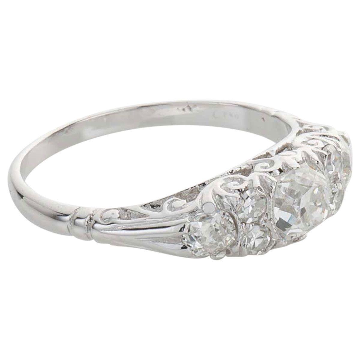 This is such a sweet ring, a delicate look on the hand. The central diamond is an old cushion cut shape with a high crown and table, it has an estimated weight of 0.30cts. Beside the central diamond are 2 single cut diamonds each side which weigh