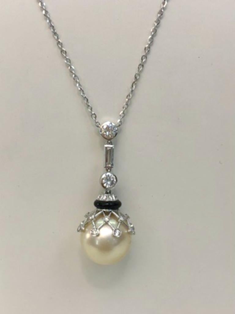Vintage Italian 18 karat white gold necklace with a 15mm diameter pearl, onyx spacer, and diamonds for a total of 1.3 carats / Made in Italy 1930s-1940s