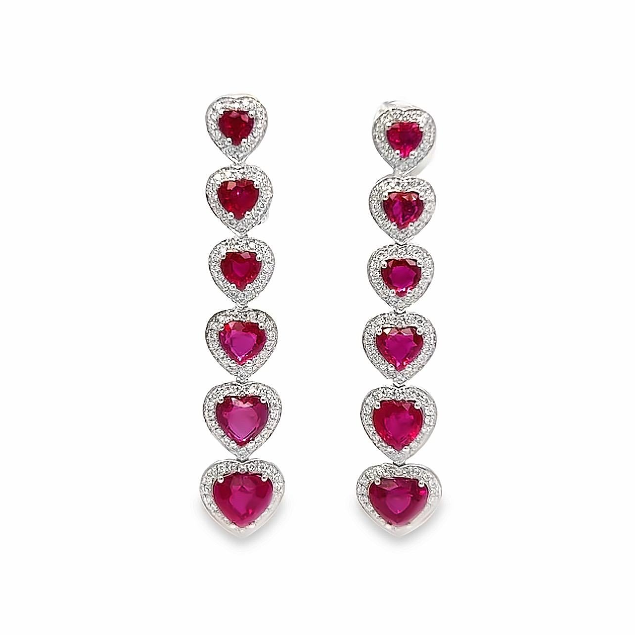 This 18K white gold elegant drop earrings are from our Timeless collection. These stud earrings are made of natural white diamonds in total of 0.60 Carat and natural heart red sapphires in total of 6.55 Carat. Total metal weight is 9 gr. They are