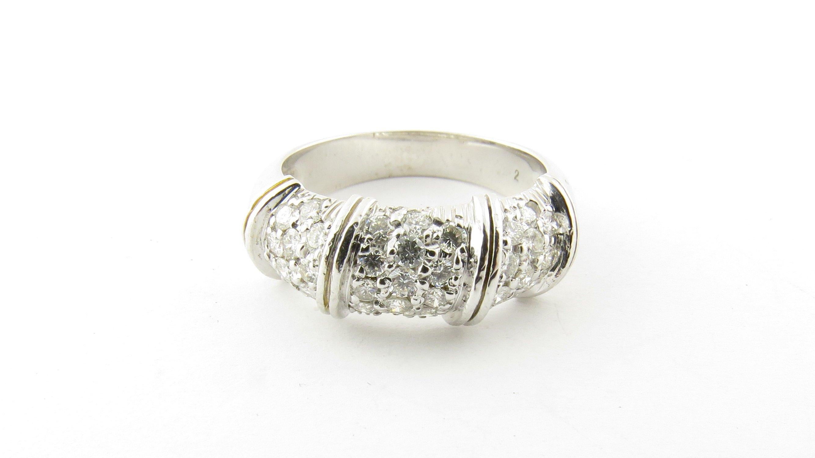 Vintage 18 K White Gold and Diamond Ring Size 6.5-This sparkling ring features 32 round brilliant cut diamonds set in classic 18K white gold. Width: 8 mm. Shank measures 3.5 mm. Approximate total diamond weight: .64 ct. Diamond color: G-H Diamond