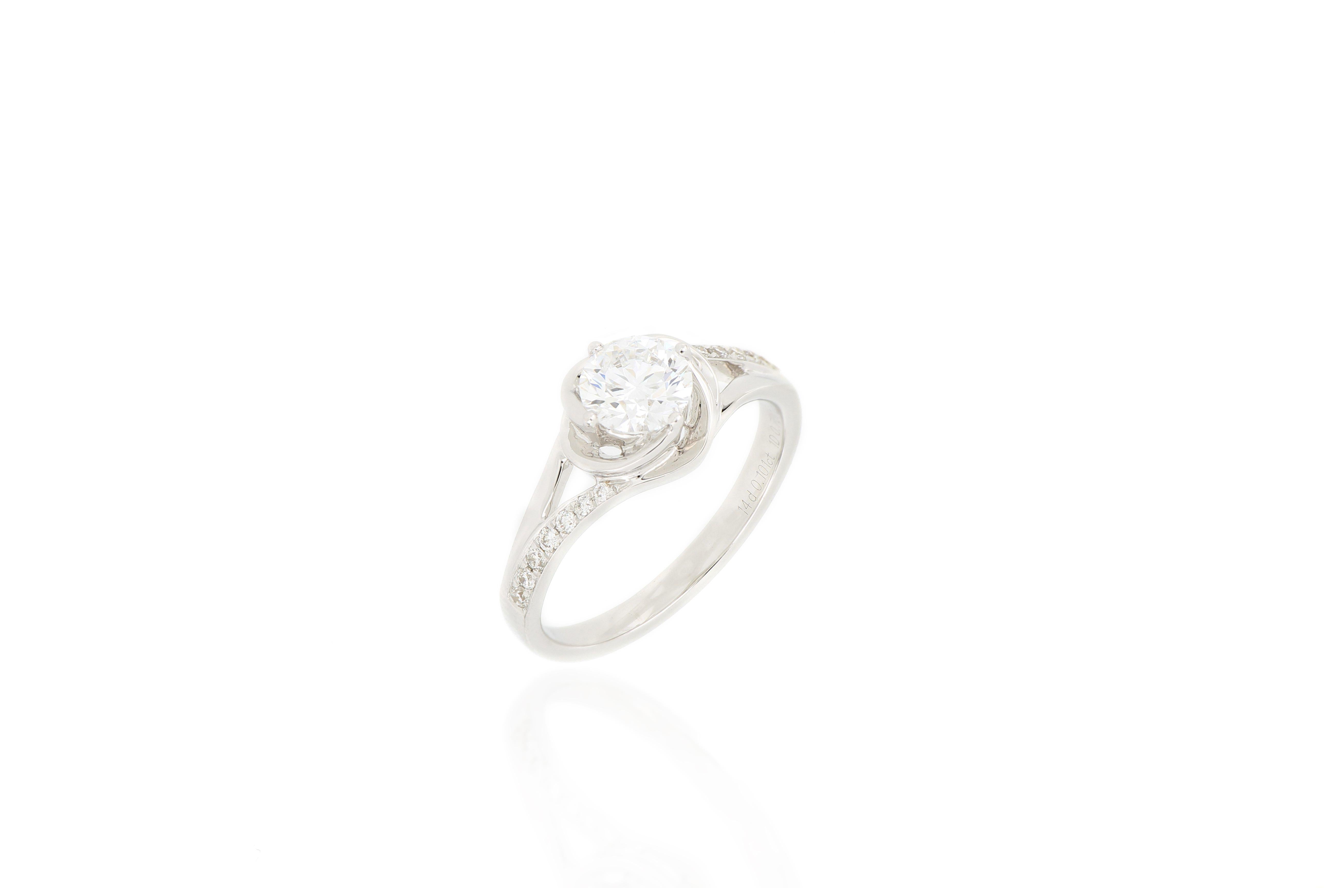 A stylish ring, set with a brilliant-cut diamond of D colour, weighing 0.70  carats, and small diamonds on the shoulder, totaling 0.10carats , mounted in 18 Karat white gold.  A very beautiful ring which can be worn for any occasion.
Accompanied by