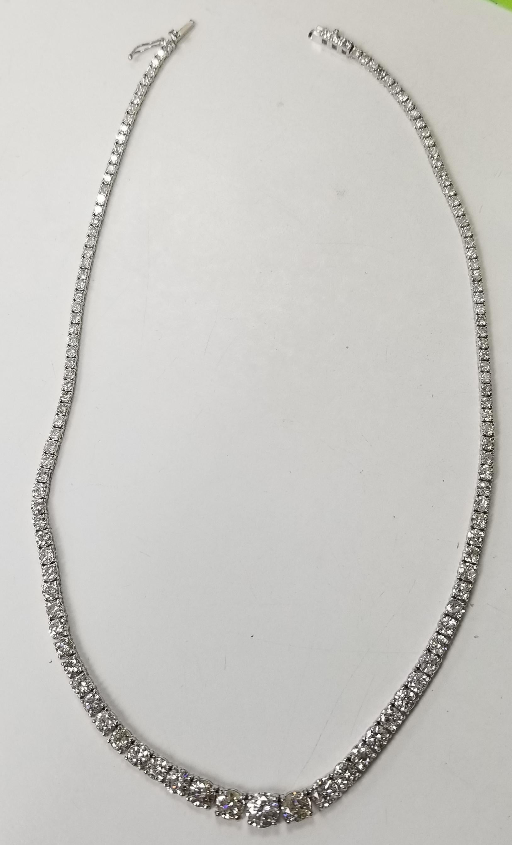 Bring the elegance of your style with this stunning diamond riviera tennis necklace. This piece has 133 pieces of diamonds in 16.09 carat total weight, G-H color and SI1-SI3 in clarity, crafted in 18k white gold.  the center diamond  weighs 1.02cts.