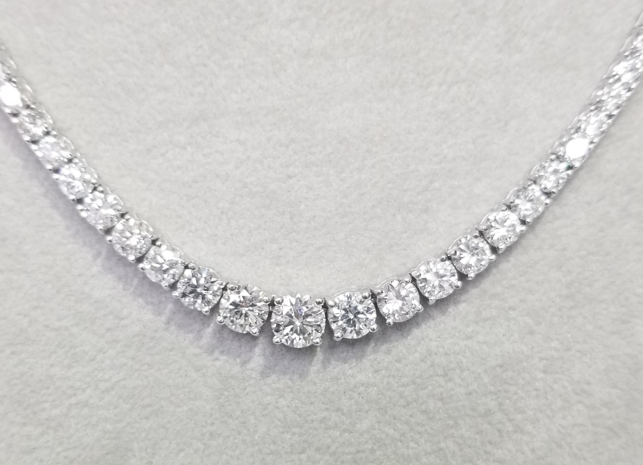 Bring the elegance of your style with this stunning diamond riviera tennis necklace. This piece has 106 pieces of diamonds in 23.26 carat total weight, F-G color and VS2-SI in clarity, crafted in 18k white gold.  the center diamond  weighs 1.00cts.