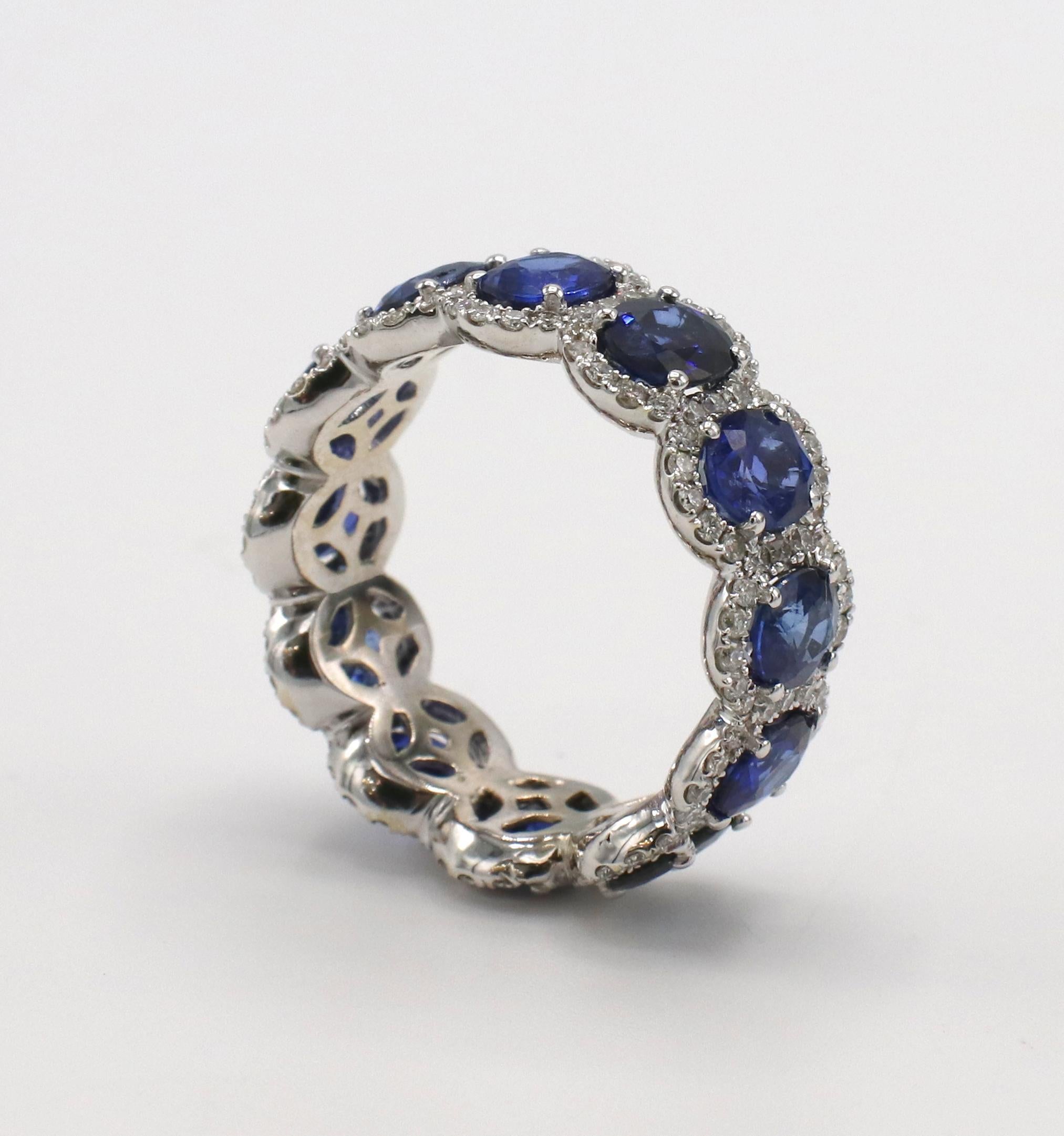 18 Karat White Gold Diamond & Sapphire Eternity Band Ring 
Metal: 18 karat white gold
Weight: 6.89 grams
Diamonds: Approx. 1.25 CTW round diamonds G VS
Sapphires: 12 oval sapphires, approx. 4.8 CTW
Size: 7.5 (US)
Width: 8.5mm
