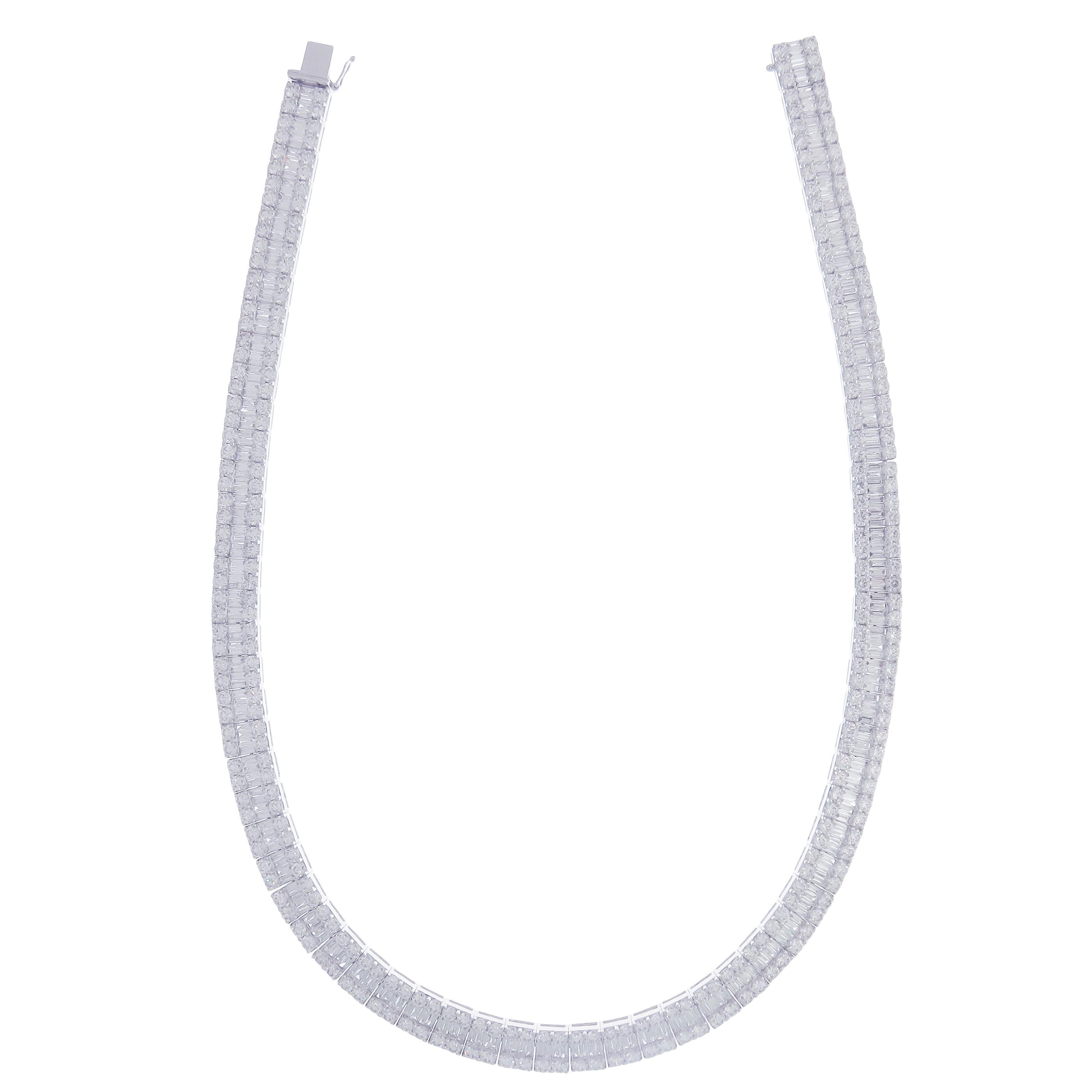 This line collection baguette necklace is crafted in 18-karat white gold, weighing approximately 34.53 total carats of V Quality white diamond. These are very comfortable, flexible, and lay flat. We have these in matching earrings as well.