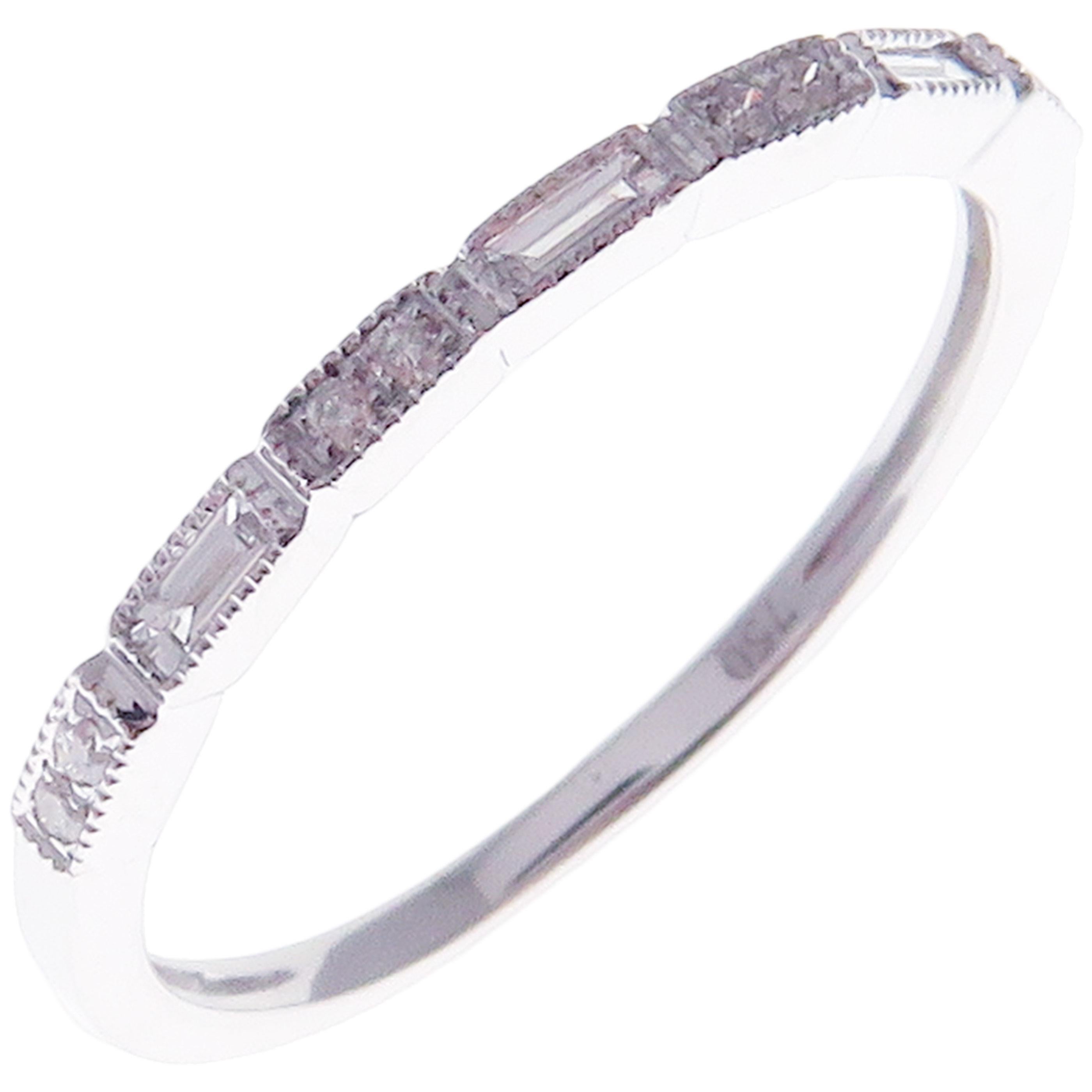 This simple stackable band is crafted in 18-karat white gold, featuring 8 round white diamonds totaling of 0.04 carats and 3 baguette white diamonds totaling of 0.11 carats.
Approximate total weight 1.50 grams.
Standard Ring size 7
SI-G Quality