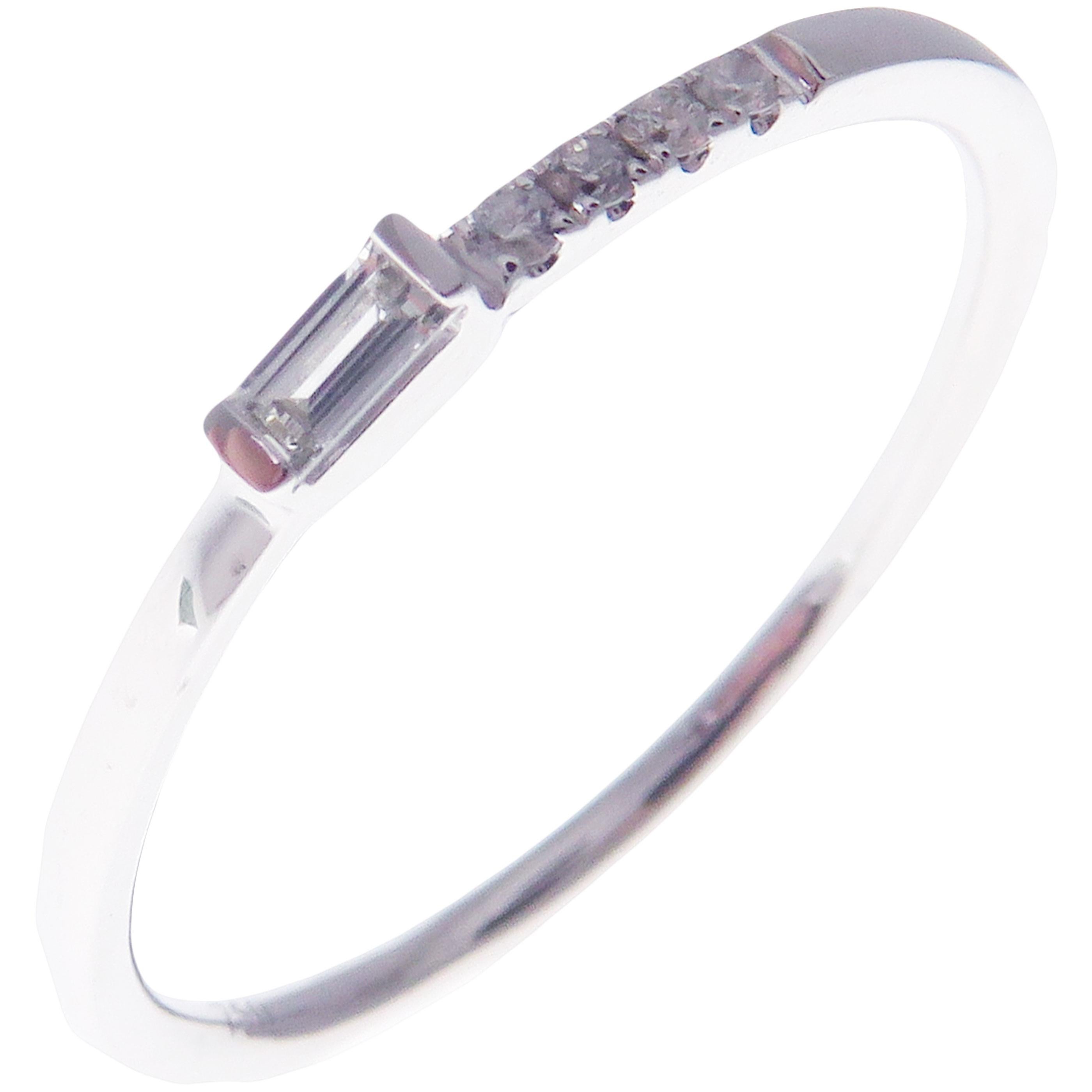 This simple stackable band is crafted in 18-karat white gold, featuring 4 round white diamonds totaling of 0.04 carats and 1 baguette white diamond totaling of 0.05 carats.
Approximate total weight 1.27 grams.
Standard Ring size 7
SI-G Quality