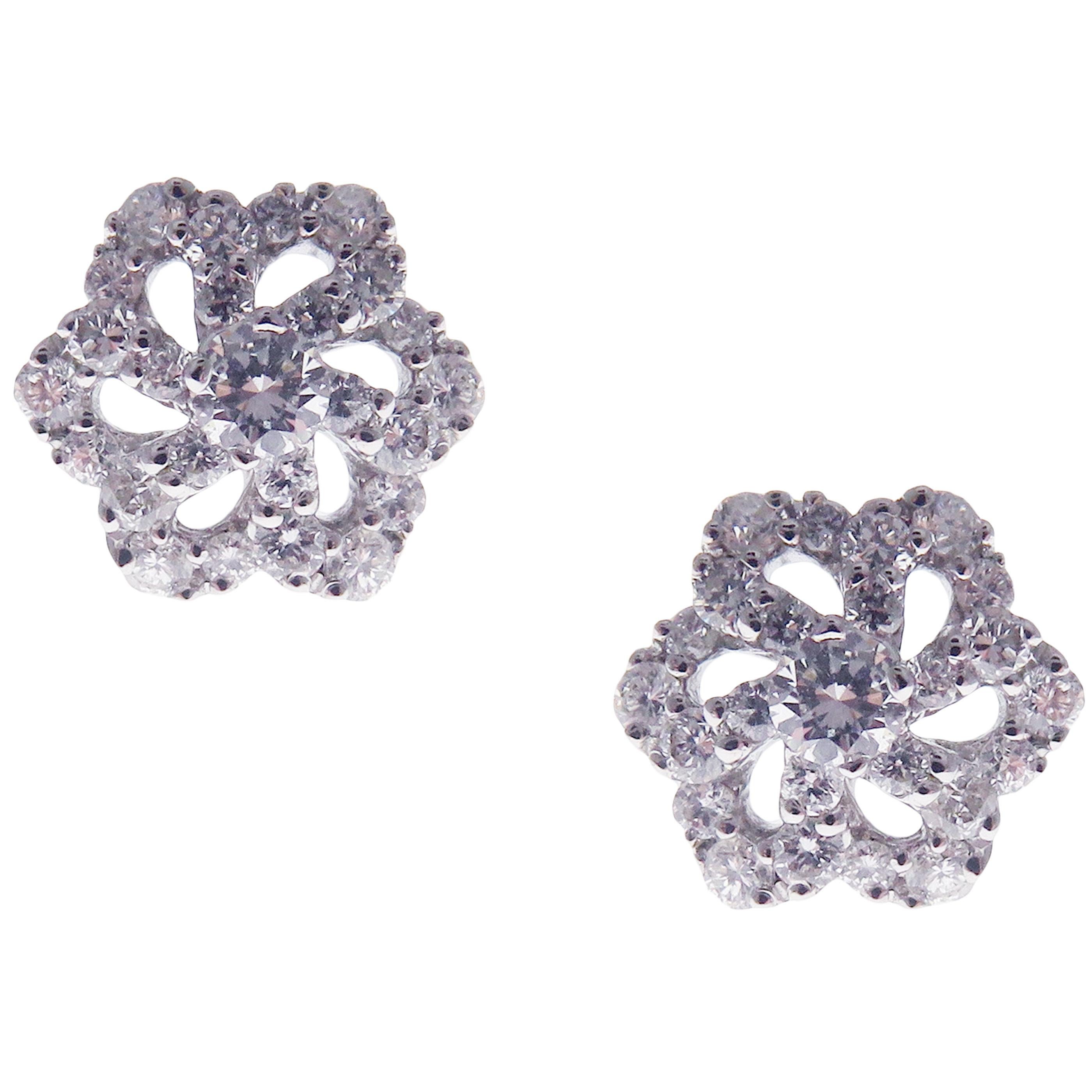 This classic diamond flower stud earring is crafted in 18-karat white gold, featuring 50 round white diamonds totaling of 0.50 carats.
Approximate total weight 2.35 grams.
These earrings come with push back post backings.
SI-G Quality natural white