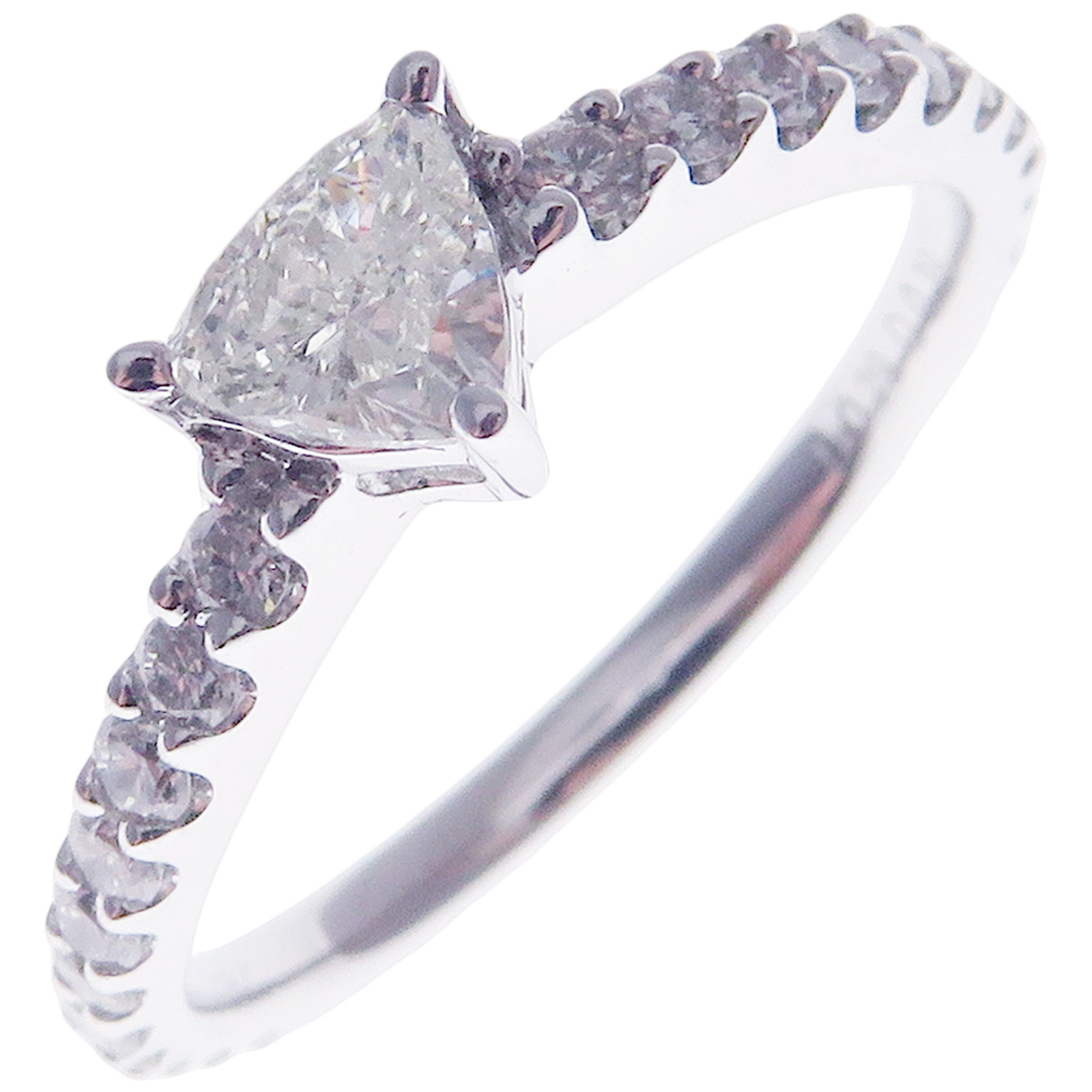 This diamond solitaire ring is crafted in 18-karat white gold, featuring 24 round white diamonds totaling of 0.39 carats with the center stone of triangle cut diamond totaling of 0.29 carats.
Approximate total weight 1.85 grams.
Standard Ring size