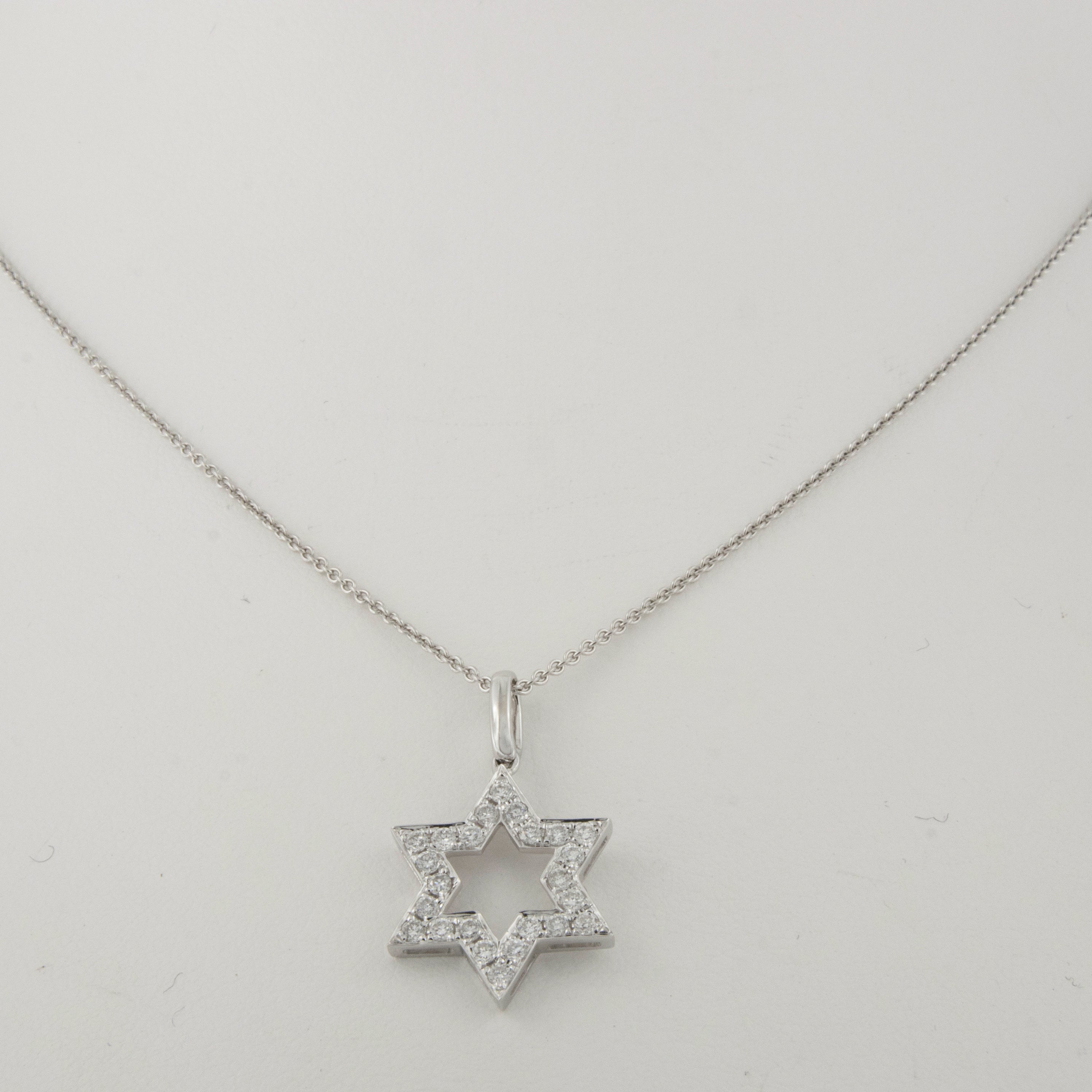 This is the perfect size for everyday and evening wear. This 18K white gold diamond Star David is pave' set with 24 F-G VS diamonds = 0.43 Cttw. and is suspended on a 18 KWG adjustable chain 18