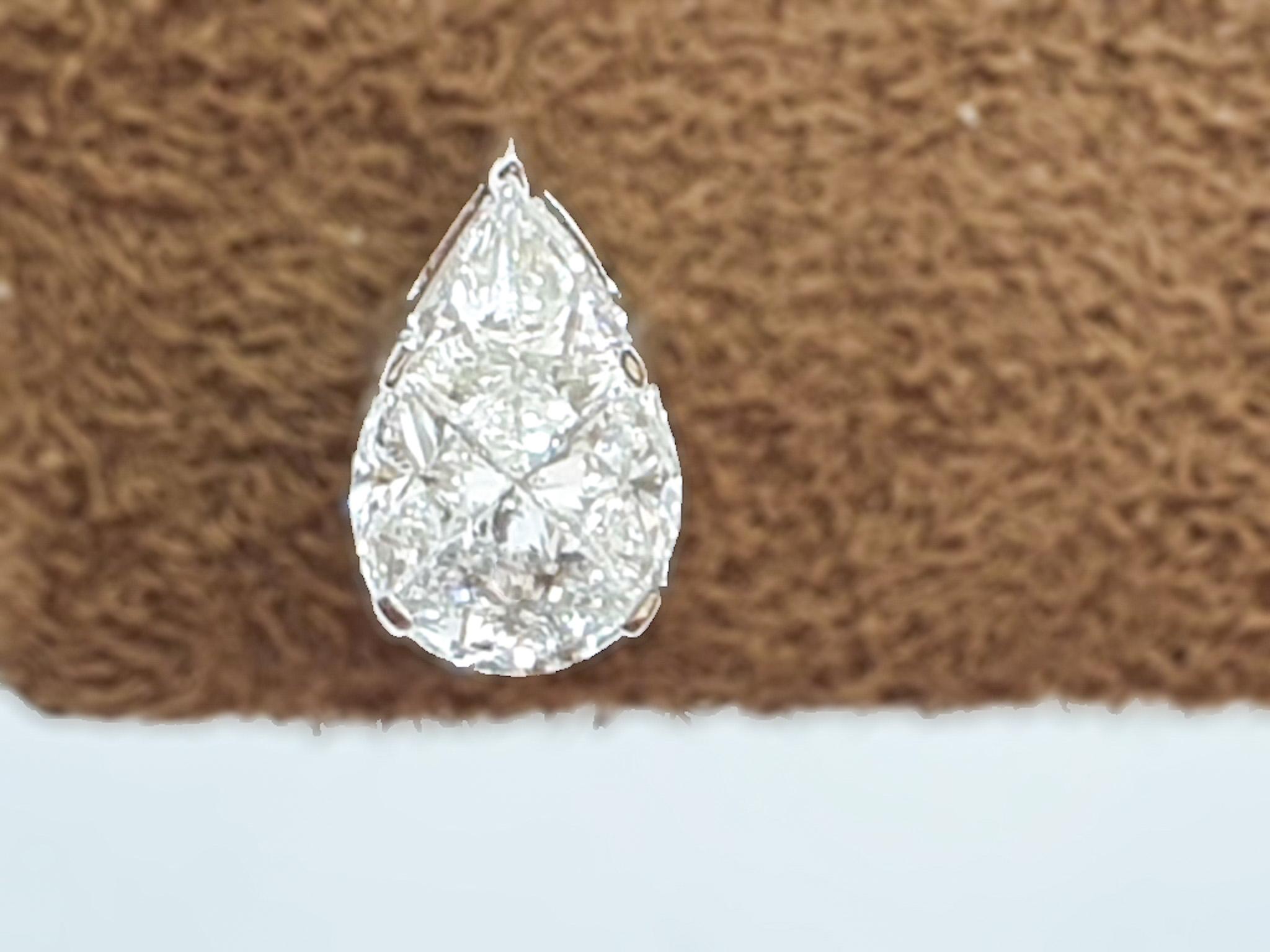 Finely calibrated fancy cut diamonds are set in 18 karat  white gold very meticulously to form a composite set centre which resembles a single pear shape solitaire. We are happy to custom make studs such as these in different shape & sizes to suit