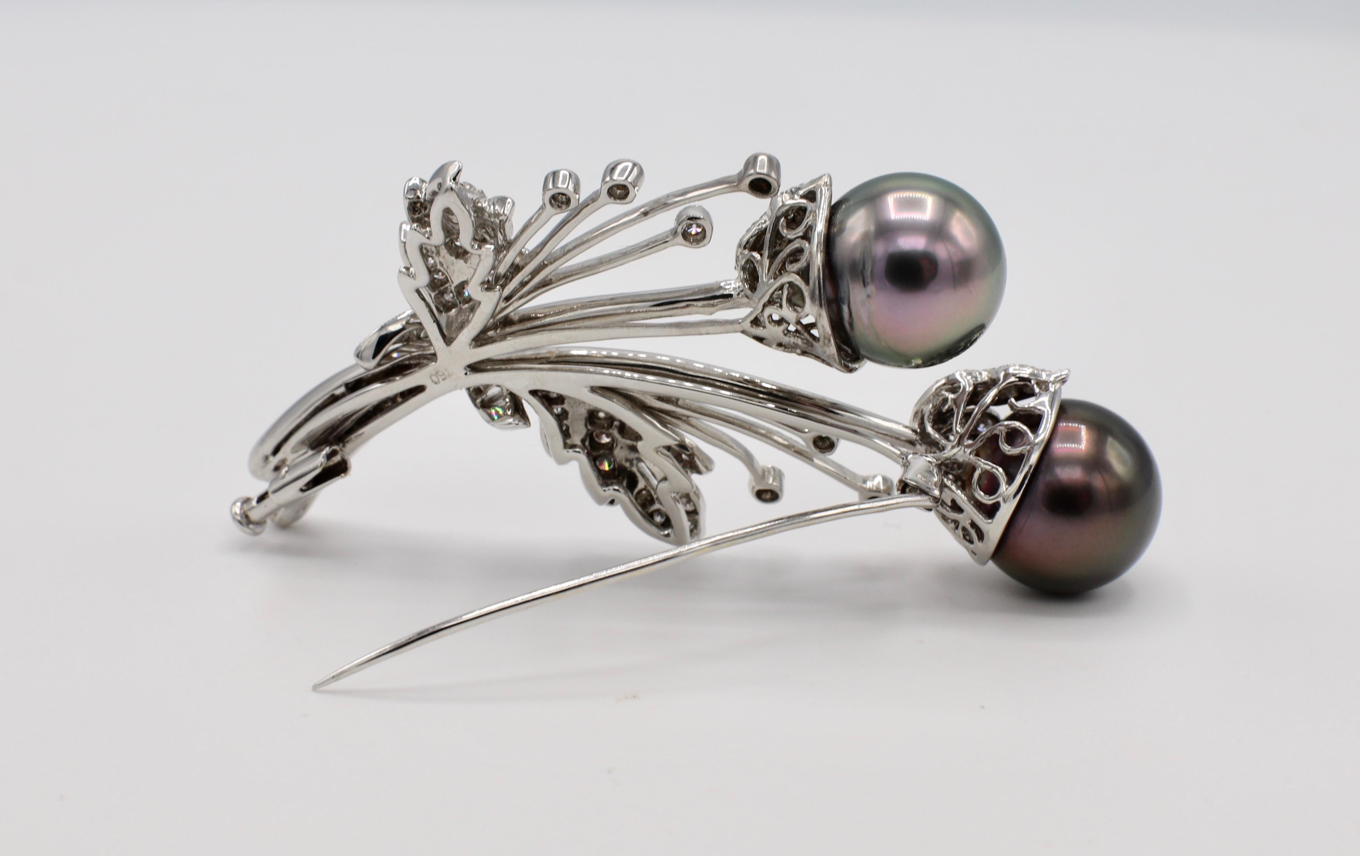 18 Karat White Gold Diamond & Tahitian Pearl Brooch Pin 
Metal: 18k white gold
Weight: 19.8 grams
Diamonds: Round & baguette diamonds, approx. 1 CTW G VS
Pearls are 12-12.5MM
Length: 60MM
Width: 33MM