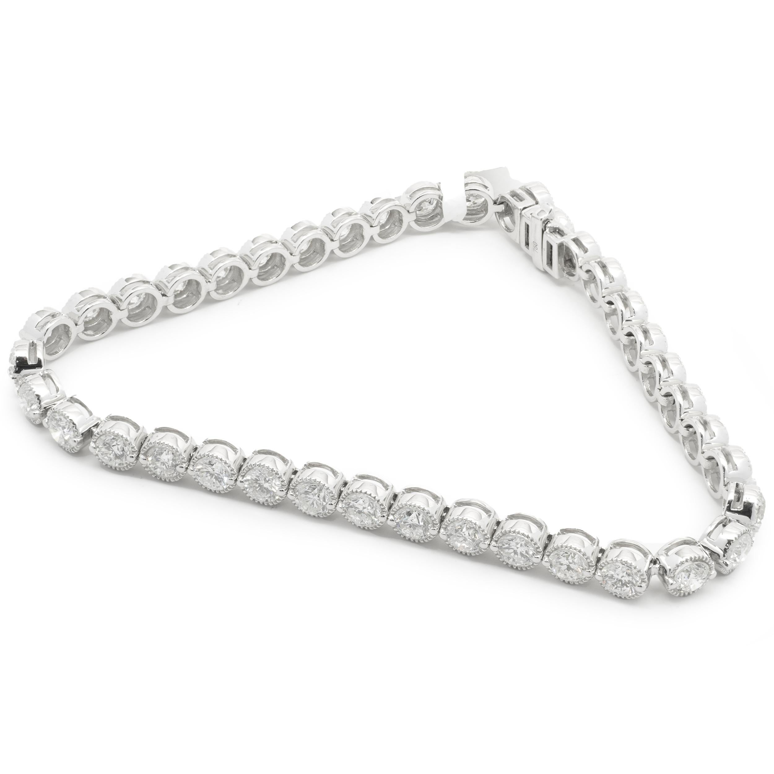 Designer: custom
Material: 18K white gold
Diamonds: 38 round brilliant cut = 7.00cttw
Color: H
Clarity: SI1
Dimensions: bracelet will fit up to a 7-inch wrist
Weight: 14.50 grams
