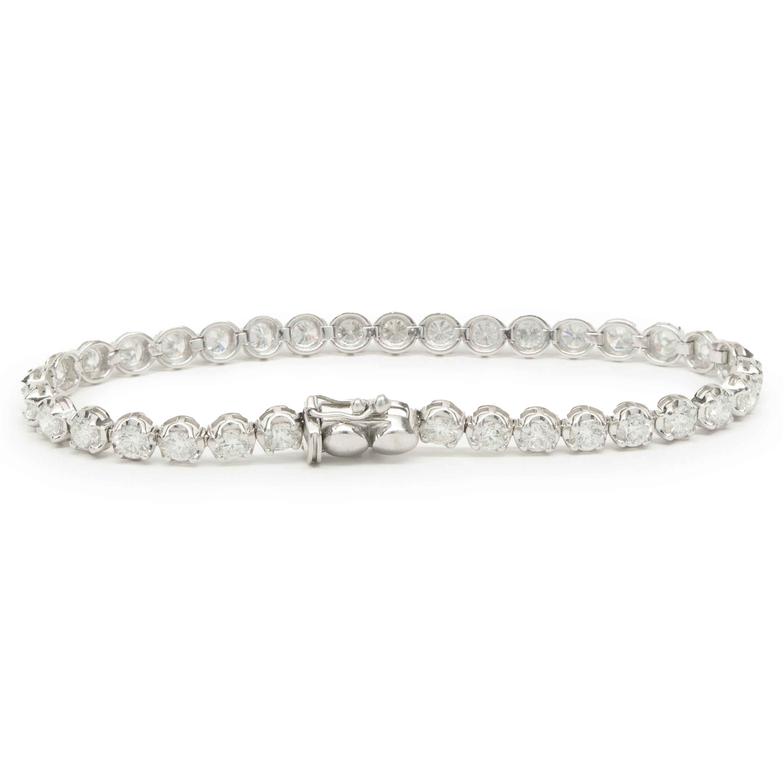 Material: 18K white gold
Diamonds: 34 round brilliant cut = 7.05cttw
Color: G
Clarity: VS-SI1
Dimensions: bracelet will fit up to a 7.25-inch wrist
Weight: 13.25 grams
