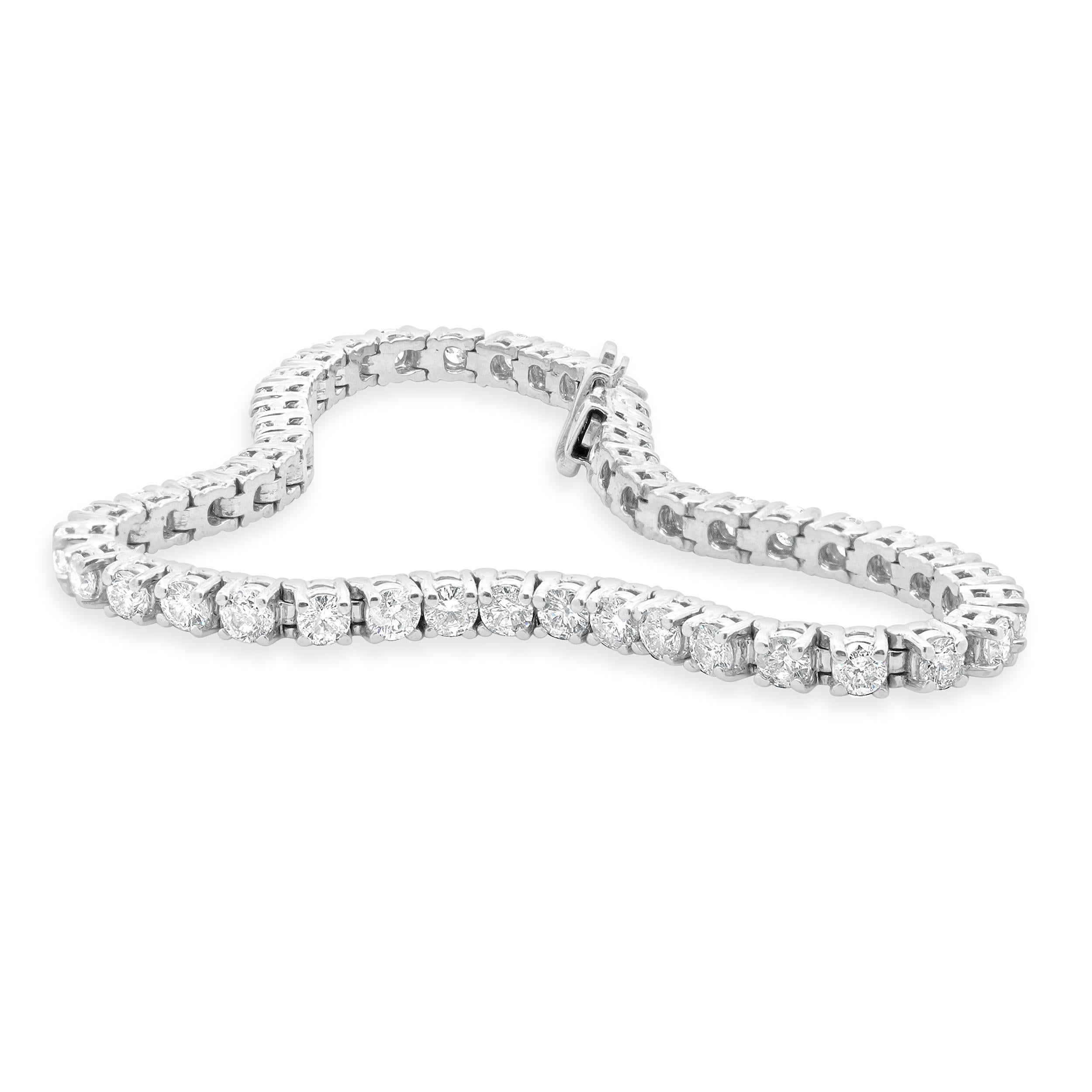 Designer: custom design
Material: 18K white gold
Diamond: 49 round brilliant cut = 5.20cttw
Color: G
Clarity: I1
Dimensions: bracelet will fit up to a 7.25-inch wrist
Weight: 12.30 grams
