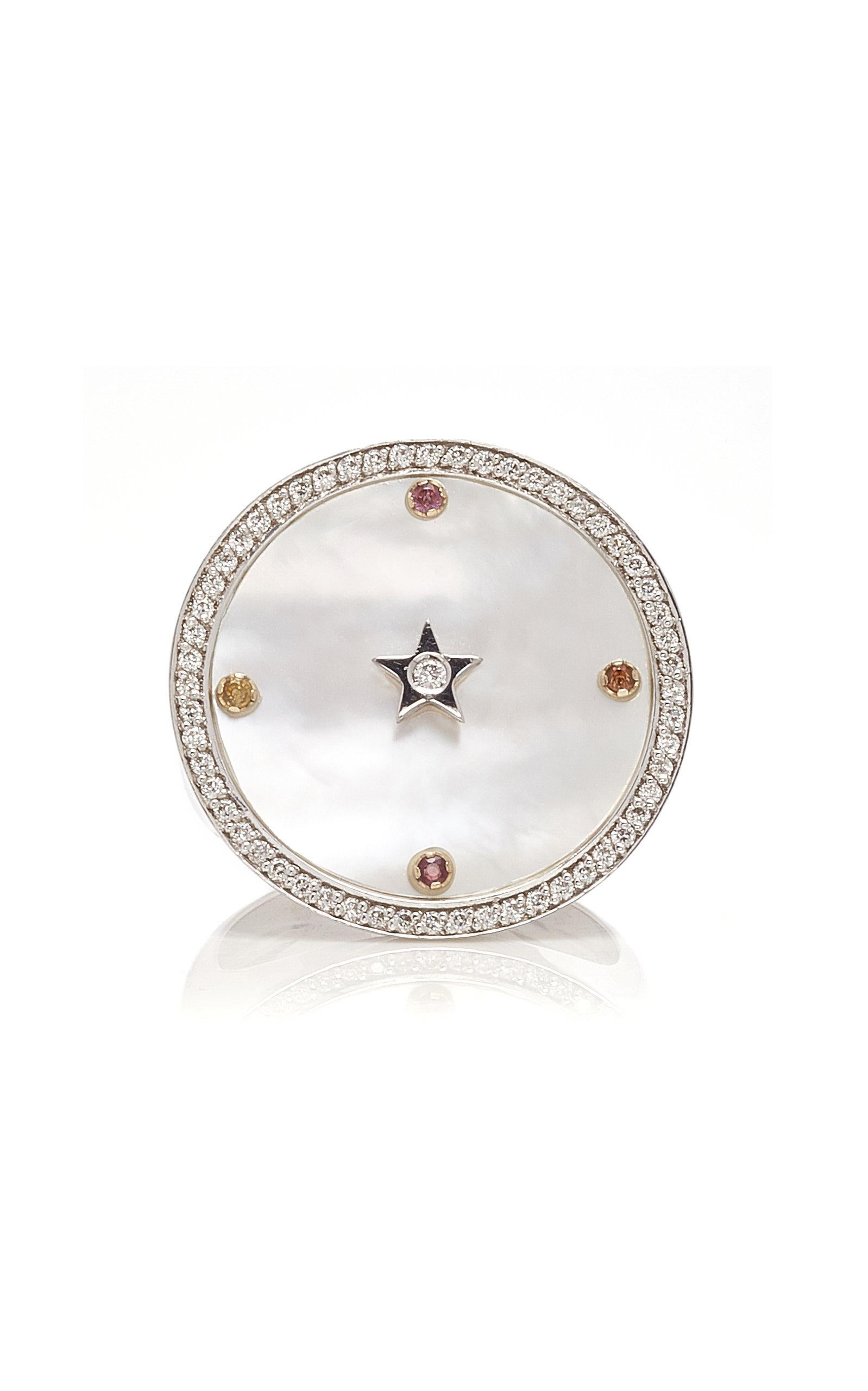 Inspired by the concept of time, Anna Maccieri Rossi's 'ORA Chevalier Ring' features a white mother of pearl dial with the hours of the day marked by multicolored sapphires with diamond star at center.
