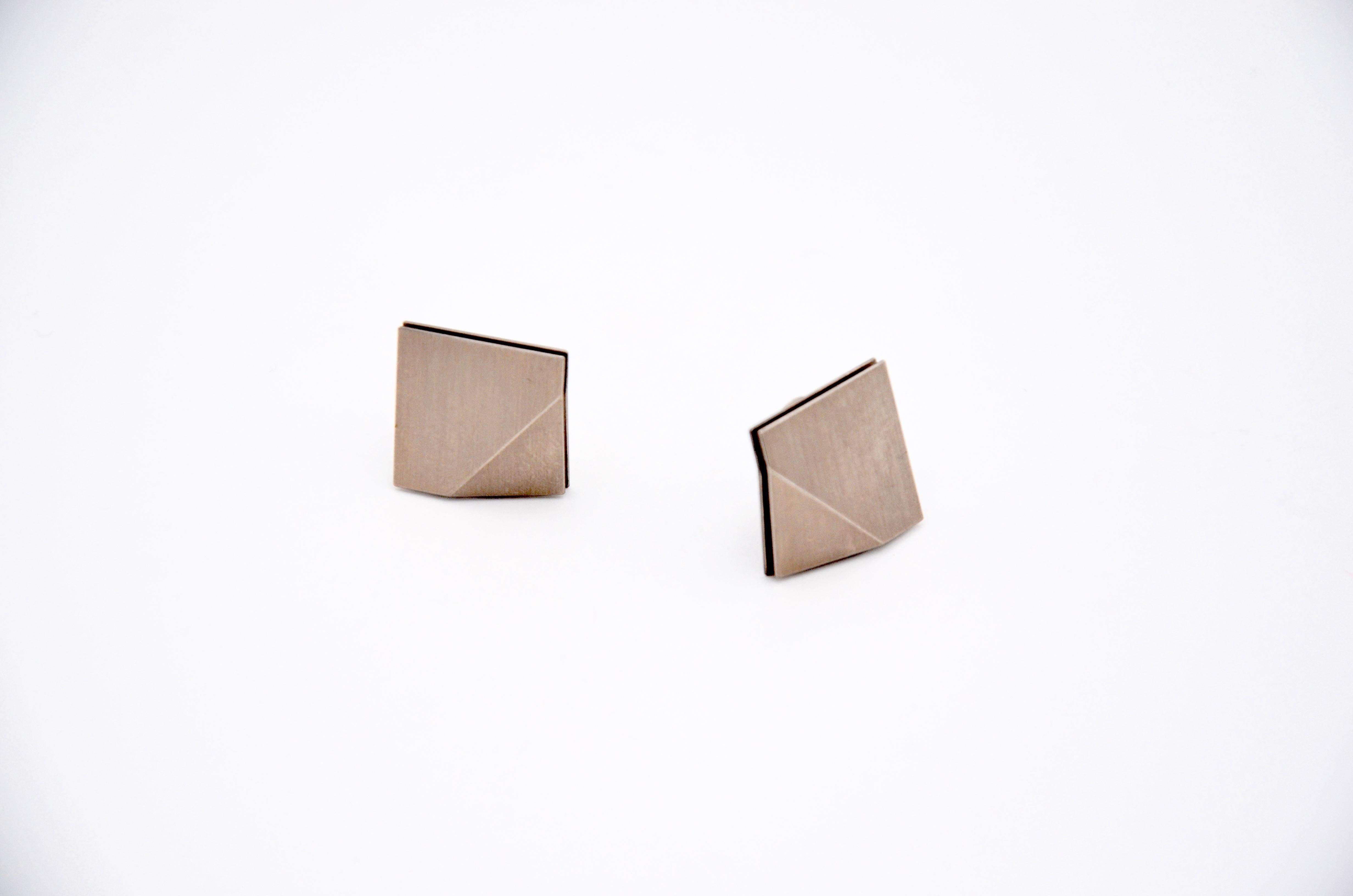 Contemporary 18 karat White Gold Ear Clips.

These craetions by Arno Schneider are delicate squares consisting of two layers and could be either Clips or customised as ear studs. The size makes them a basic go to piece that has this twist through
