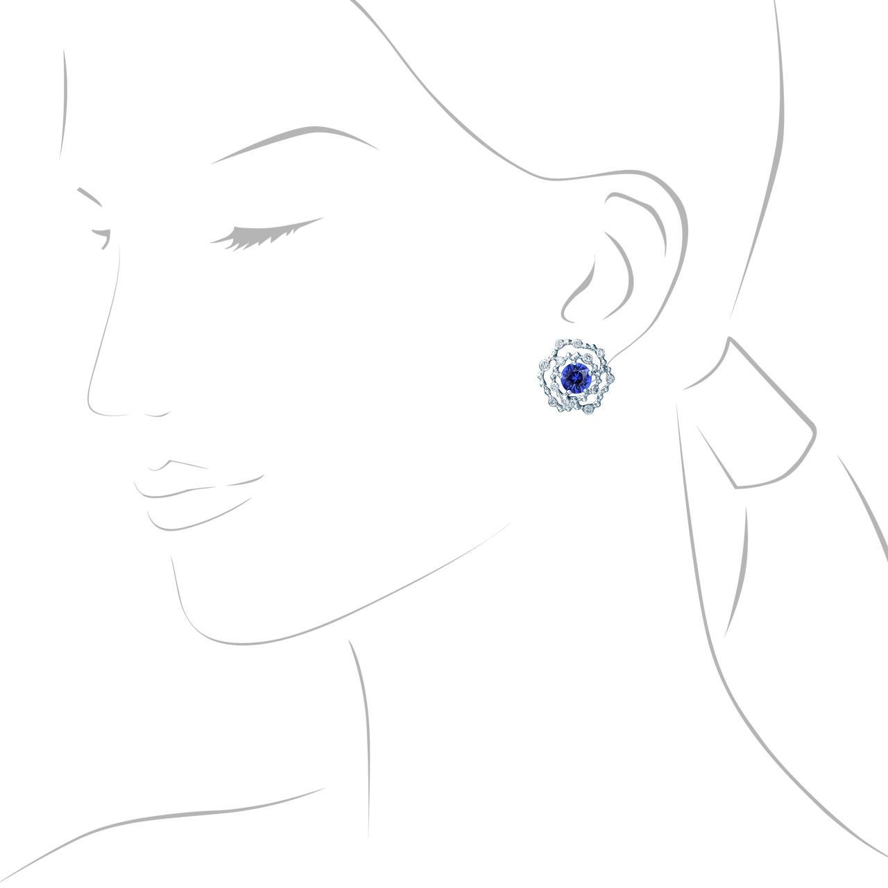 - 24 Round Diamonds - 0.43 ct, G/VVS1-VS1
- 2 Round Sapphires - 2.46 ct
- 18K White Gold 
- Weight: 6.31 g
These elegant earrings from the Byzantium collection is adorned with 2.46 carat sapphires surrounded by diamonds on gold lace. The dazzling