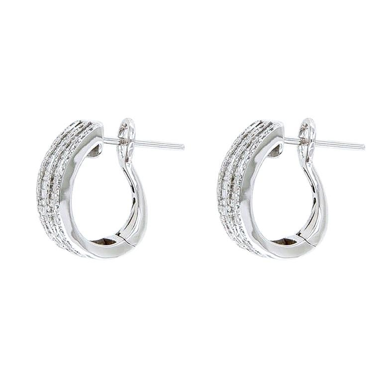 The earrings are a semi-circle design, set with two rows of baguette-cut diamonds and three rows of brilliant-cut diamonds, for a total carat weight of 1.54 ct. 
Their closure has the clip and the pin for the hole in the lobe. 
The earrings are in
