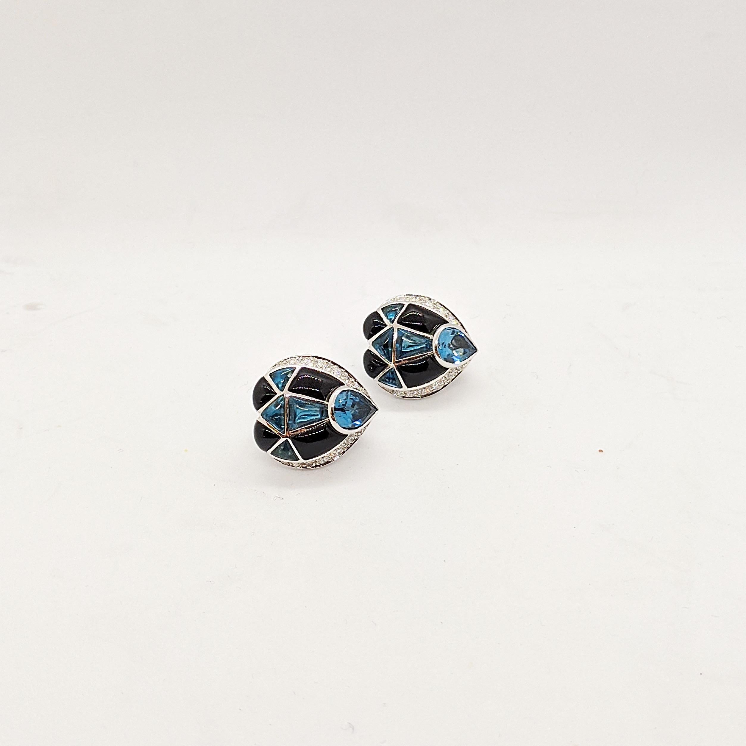 These earrings were designed by Oro Trend of Italy. The 18 karat white gold teardrop shaped earrings are set with Diamonds, Blue Topaz and Black Onyx. They have a french clip back with a fold down post making them suitable for pierced and non