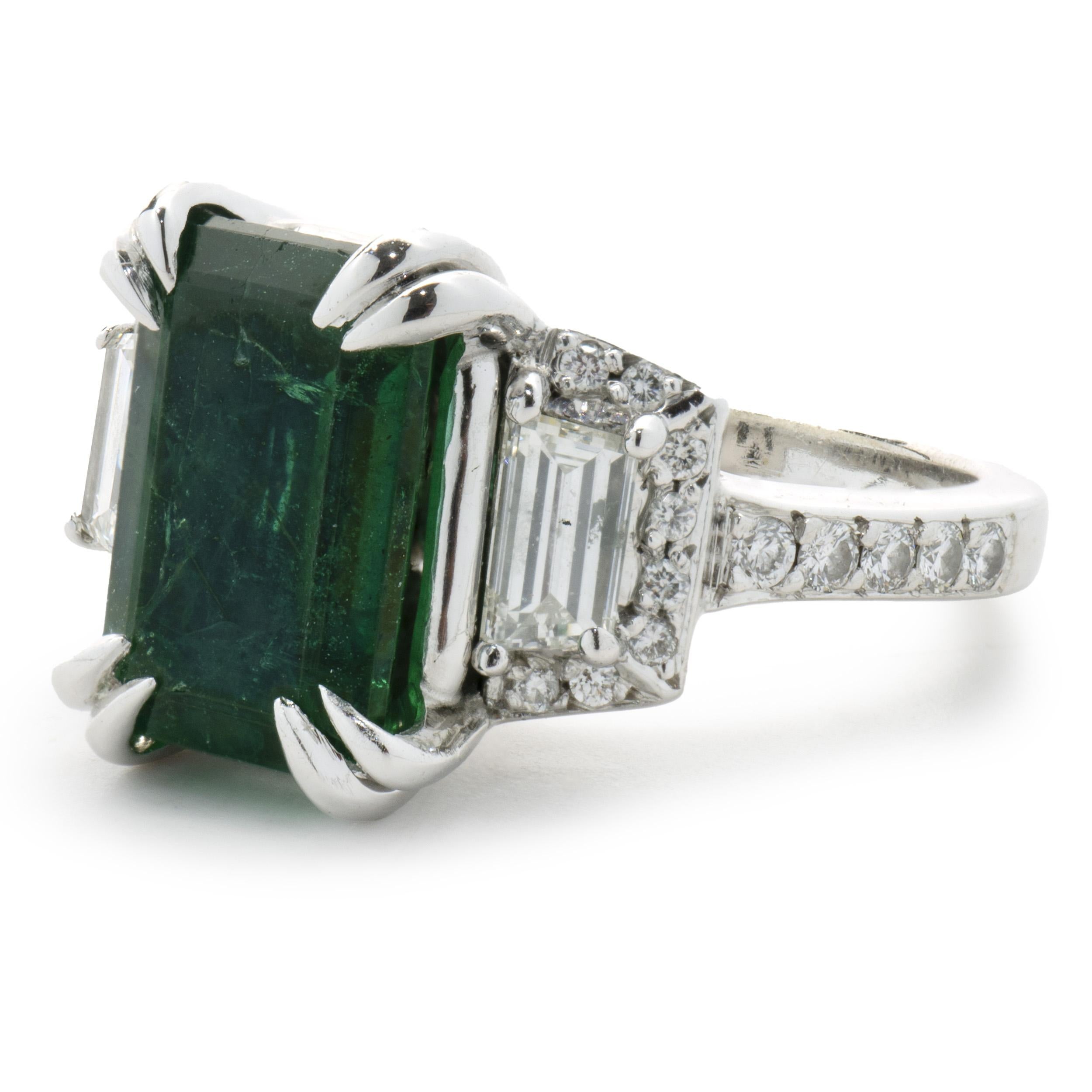 Designer: custom design
Material: 18K white gold
Diamond: 30 round brilliant cut = 0.71cttw
Color: G
Clarity: VS1-2
Emerald: 1 emerald cut = 3.00ct
Color: Shamrock
Clarity: AA
Dimensions: ring top measures 12mm wide
Ring Size: 5.5 (please allow two