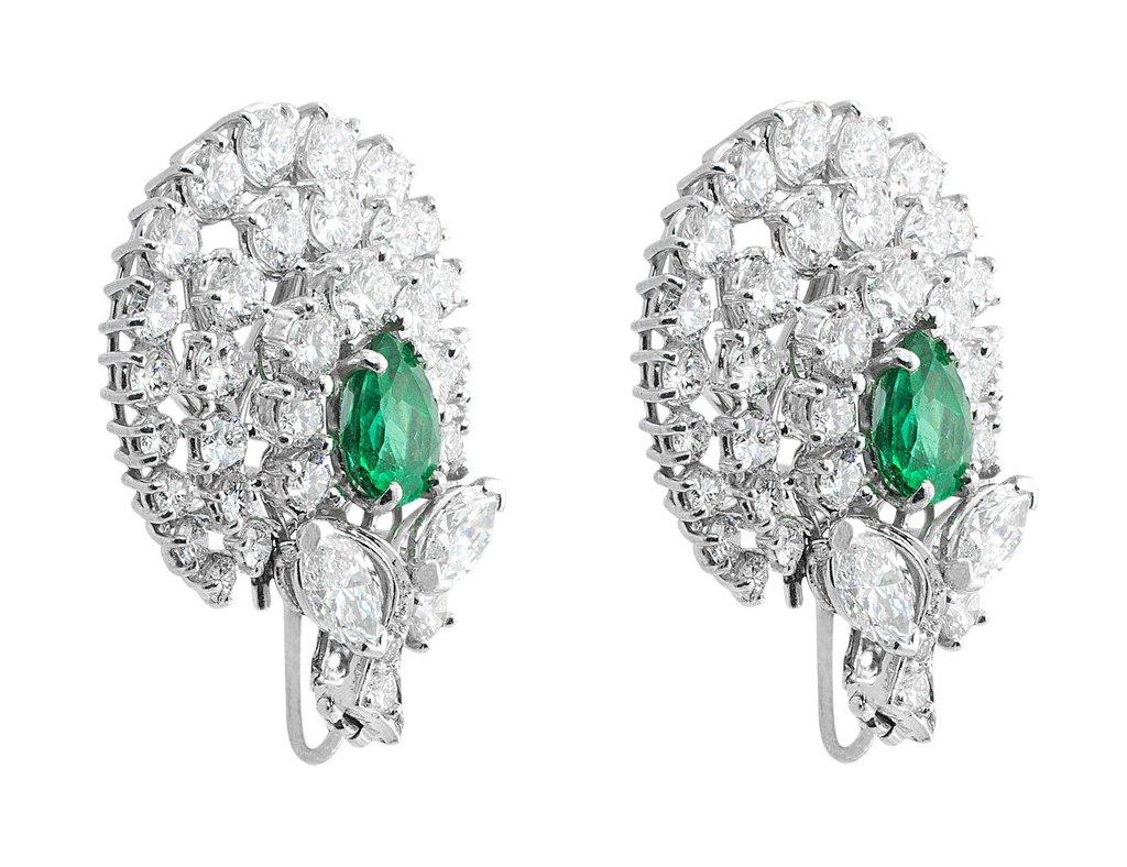 18k white gold lever back earrings. Lovely vintage styling with elegant pear shaped emeralds surrounded by a cloud of pavé diamonds with a stem of round brilliant cut diamonds enhanced with two marquise diamonds. The emeralds are estimated at 2ct